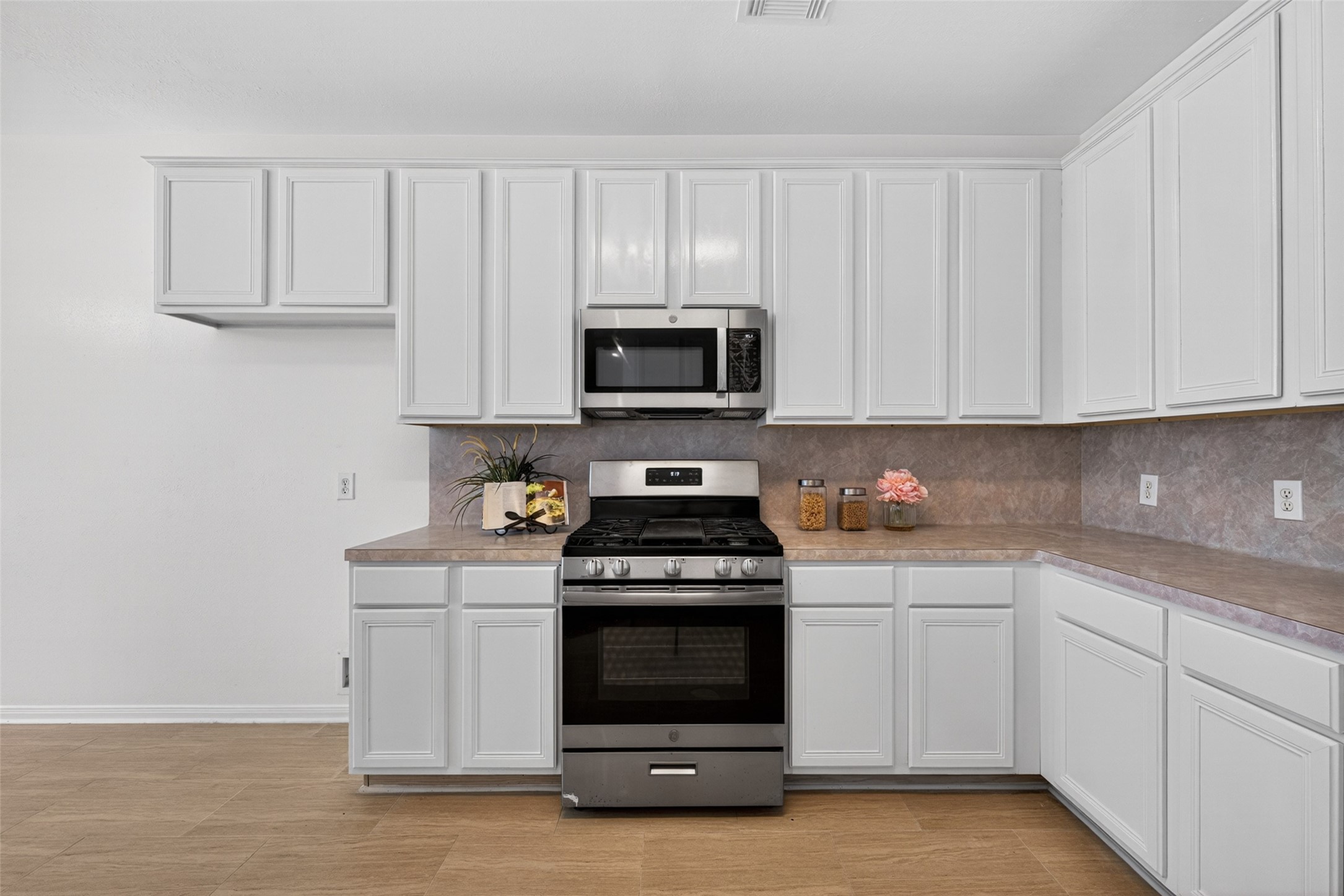 It comes fully equipped with modern stainless steel appliances and connects directly to a charming breakfast area.