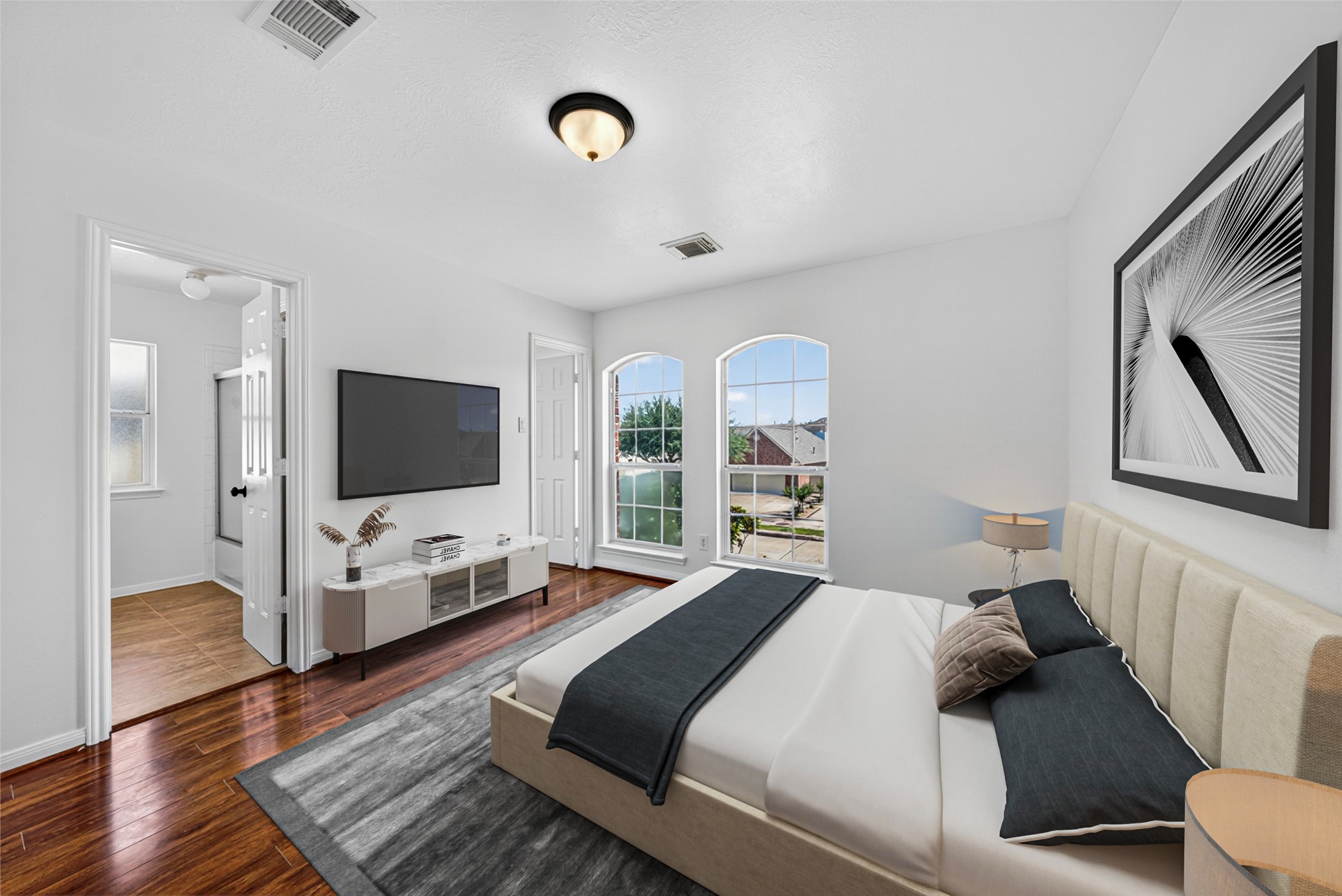 This charming third bedroom radiates an uplifting energy, with its unique arched windows flooding the space in soft, natural light.