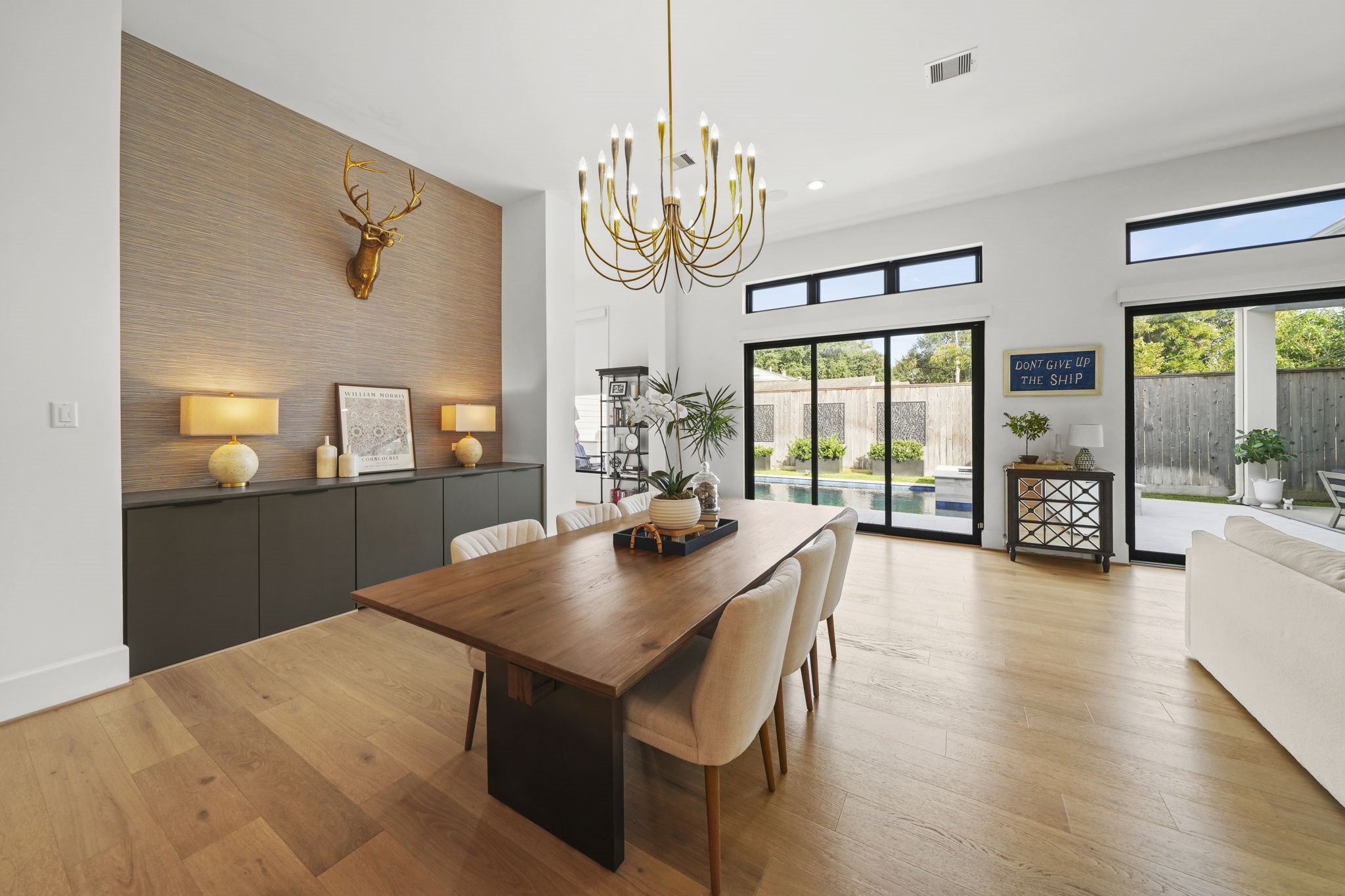 The dining room is complete with a built in buffet, custom chandelier and is open to the family room and the backyard!