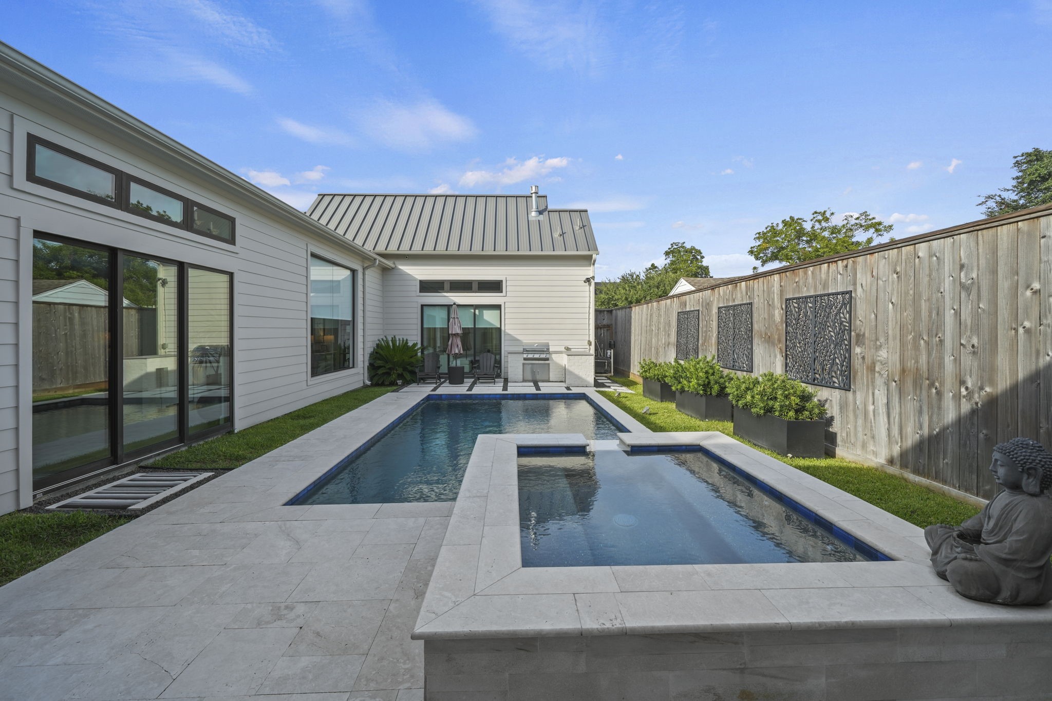 The backyard is an oasis complete with pool and spa, outdoor kitchen and amazing outdoor living space!