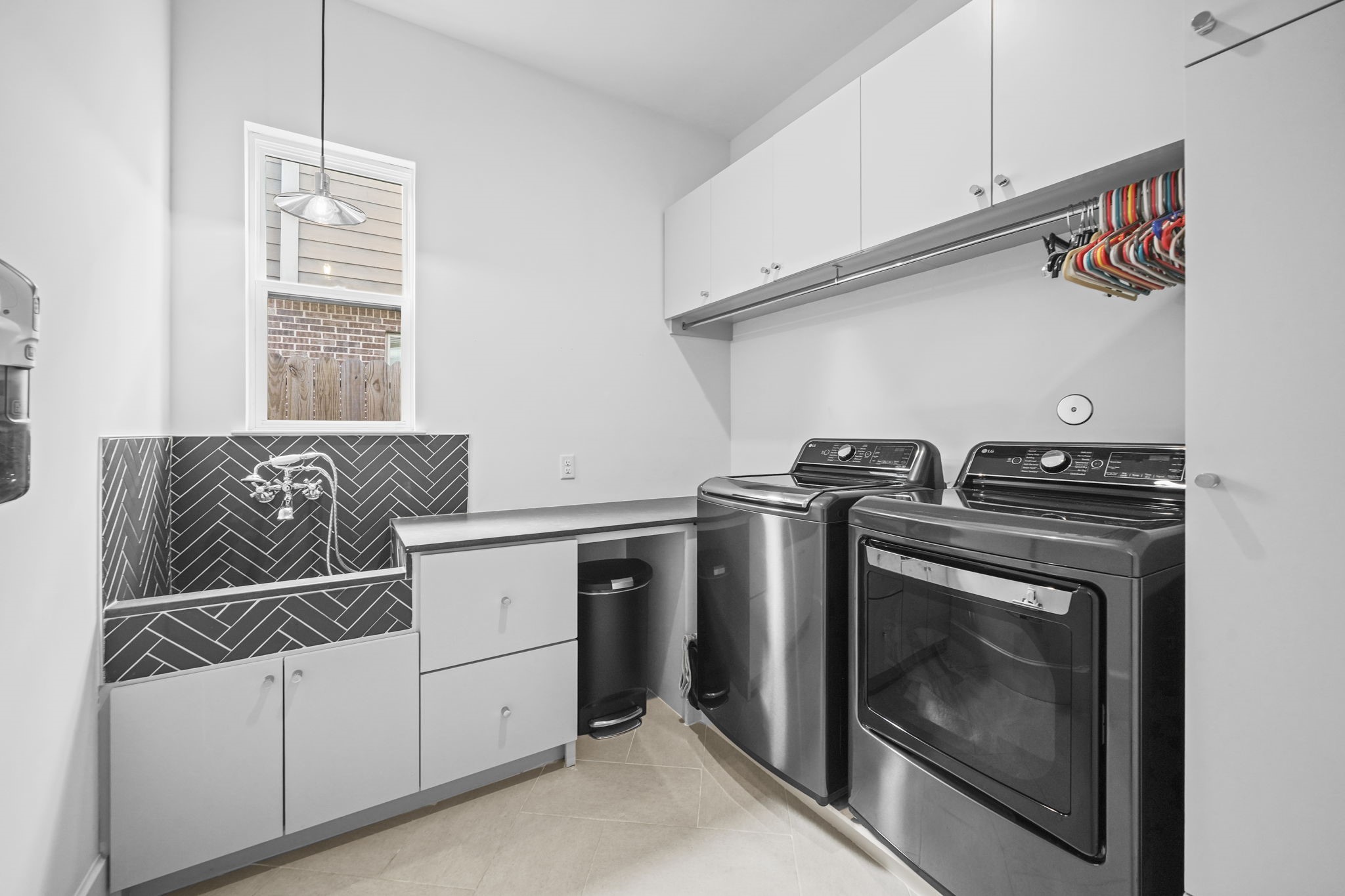 The amazing laundry room has a dog wash station and the washer and dryer convey with the home!