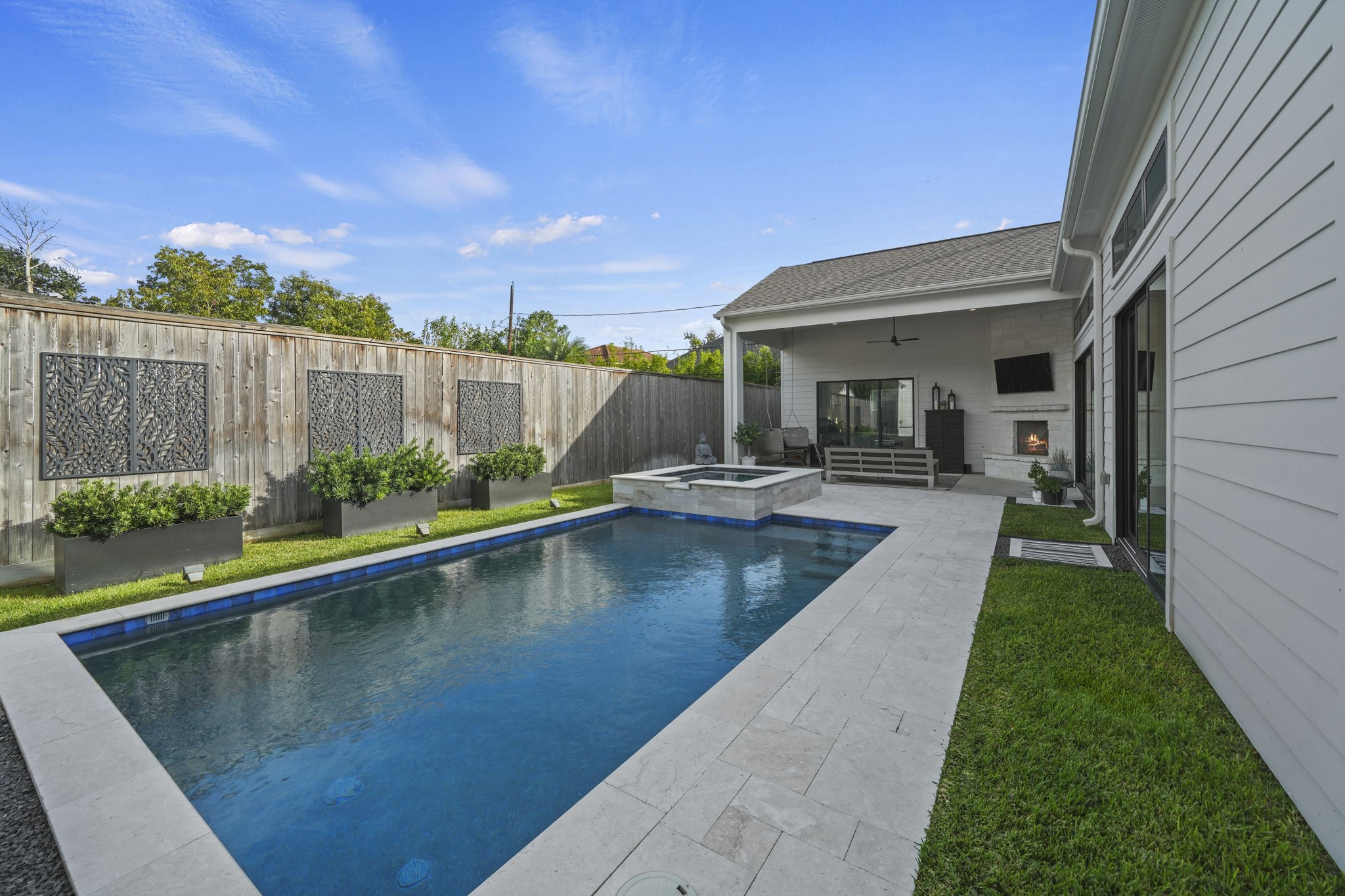 The gorgeous pool and spa are positioned perfectly in the backyard and an 8 foot fence provides so much privacy!