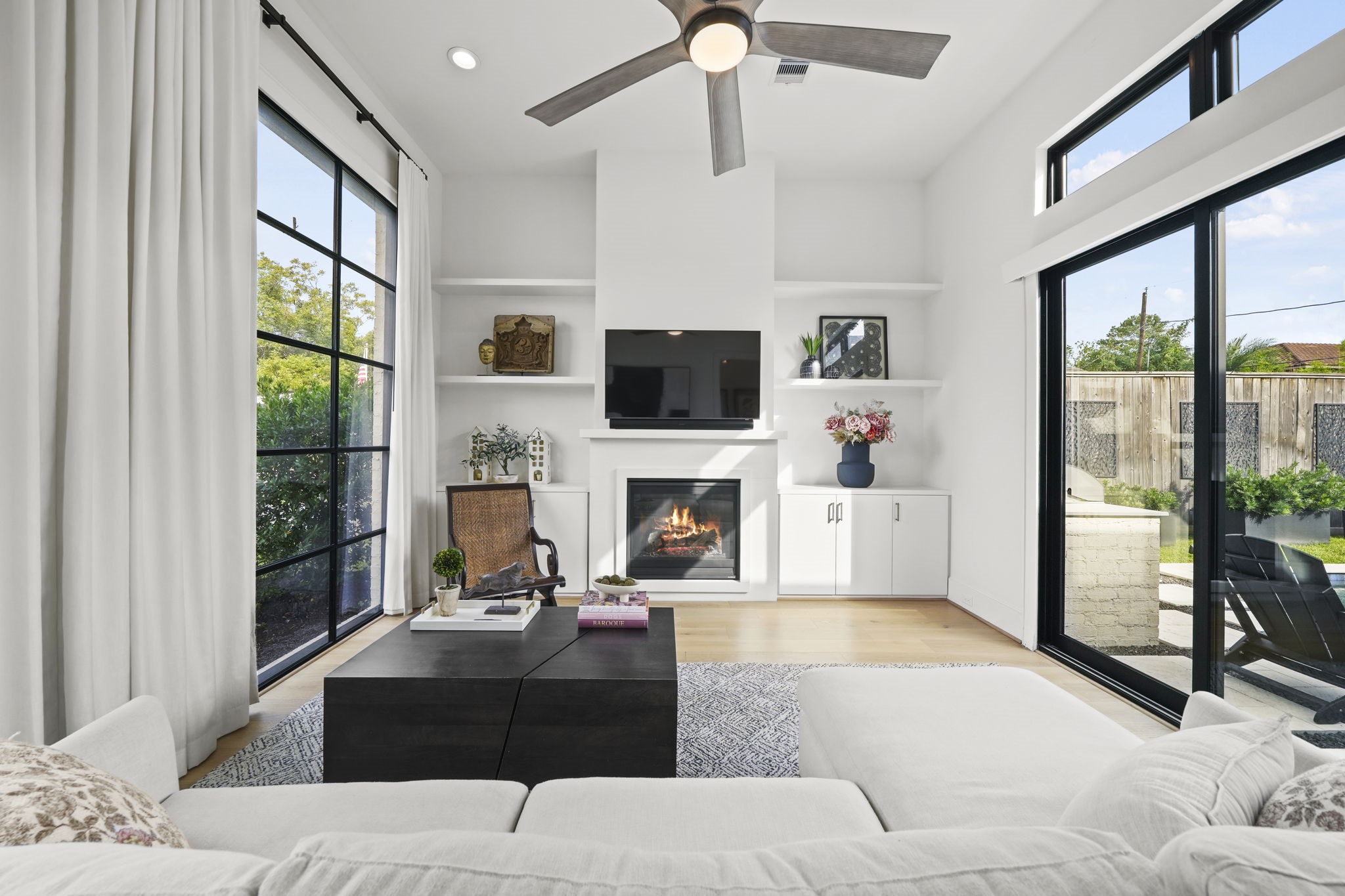 The second living space or office with a wall of windows and sliding doors out to the outdoor space!