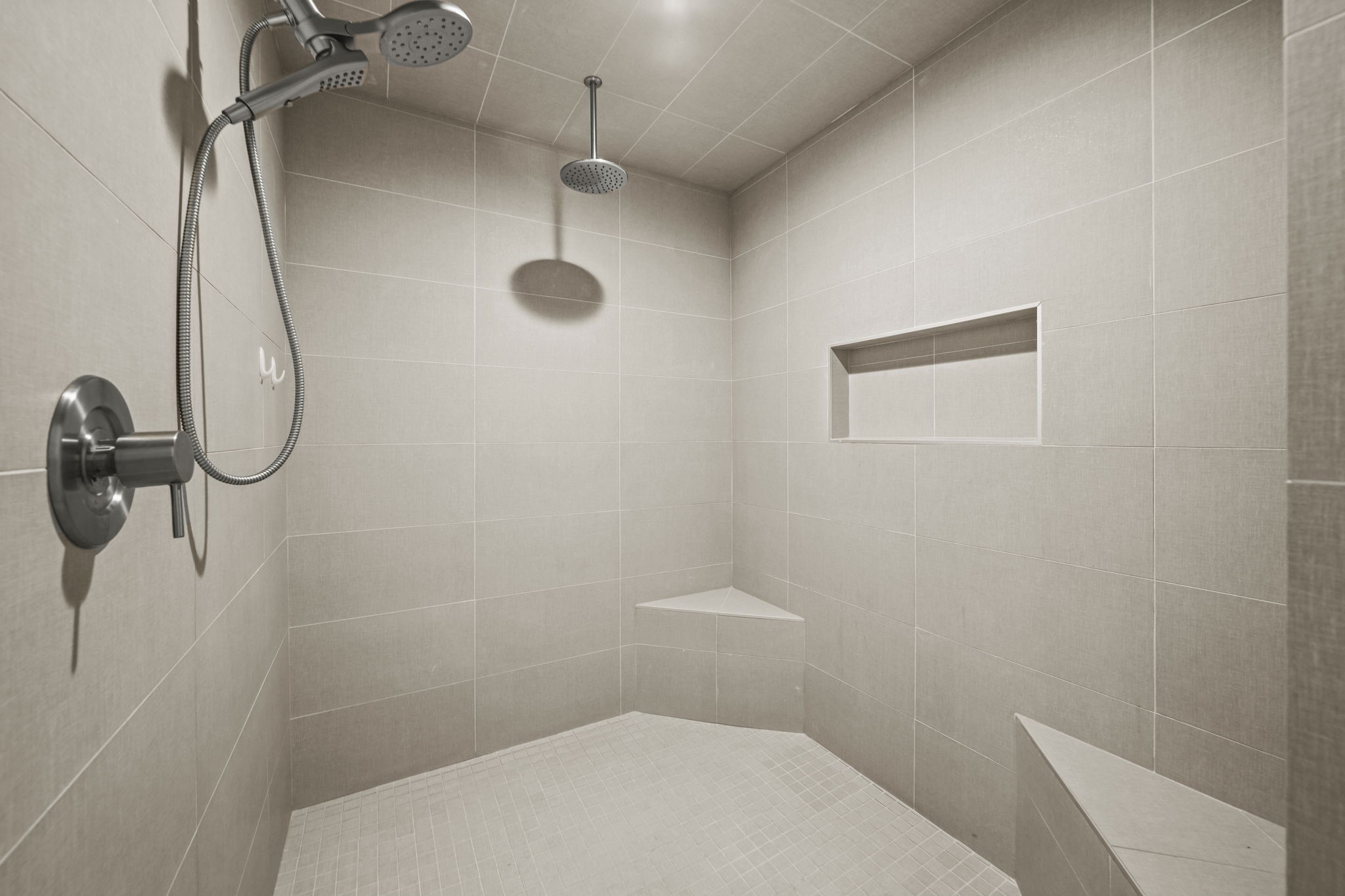 The very large shower in the primary bath with rain shower head, seating and an alcove!
