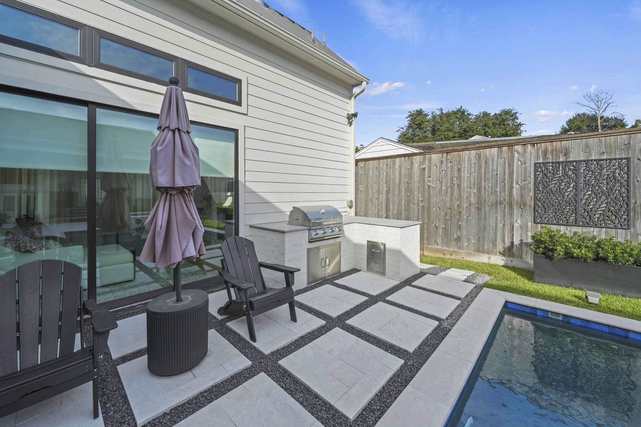 The gorgeous outdoor kitchen with pavers add even more outdoor living space!