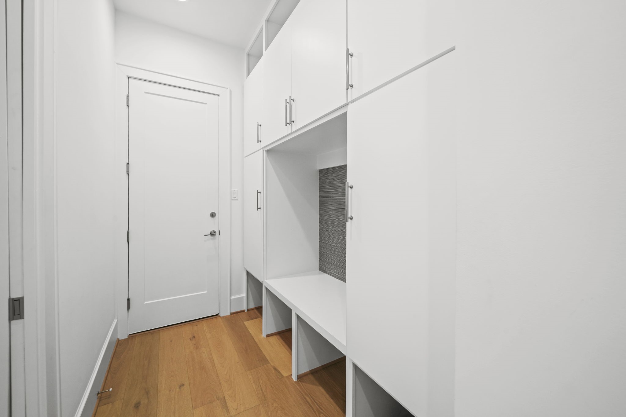 What a great use of space with built ins right inside the garage door!