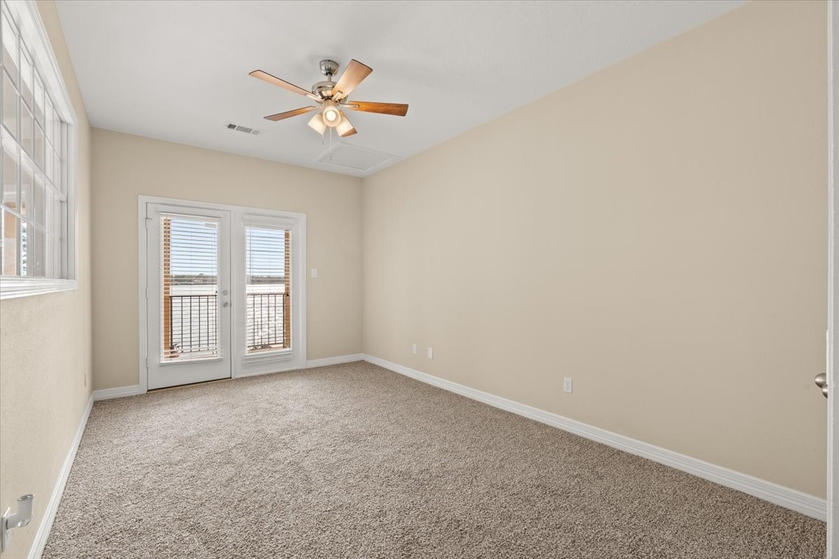 Upstairs bedroom with ceiling fan