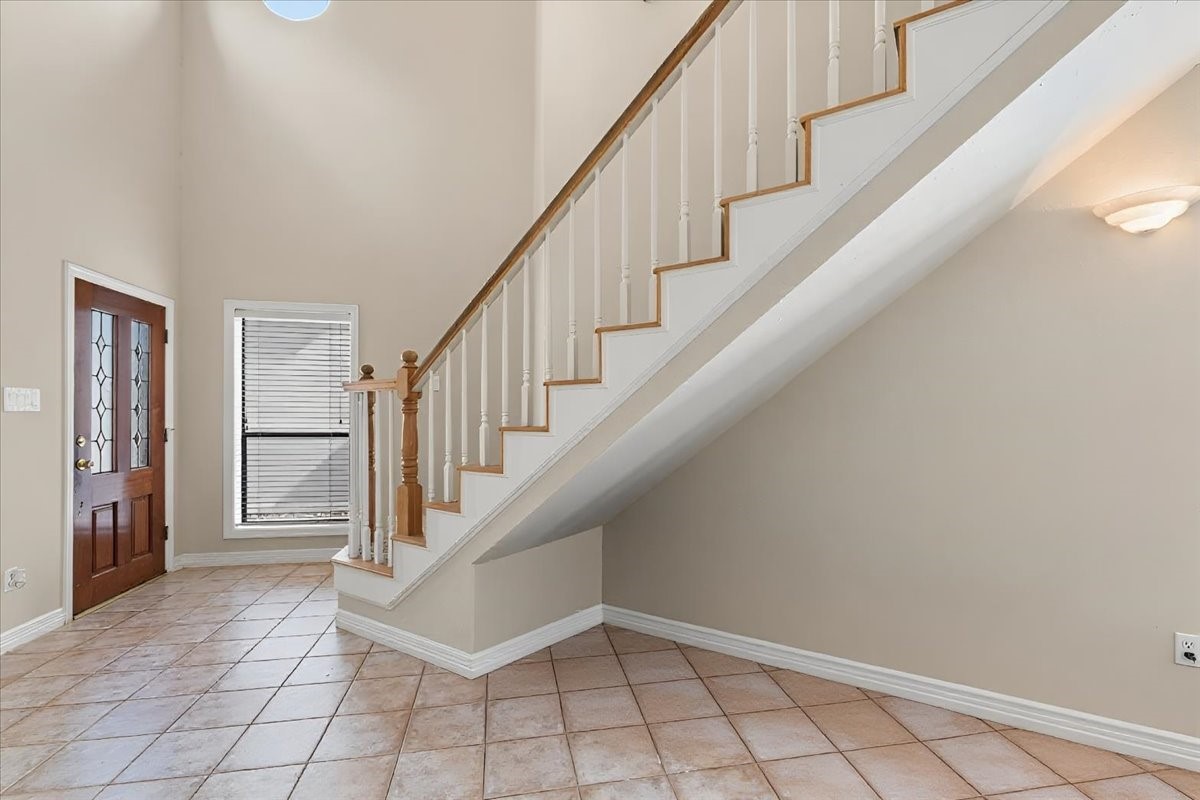 Entry with high ceilings and light flooding the space