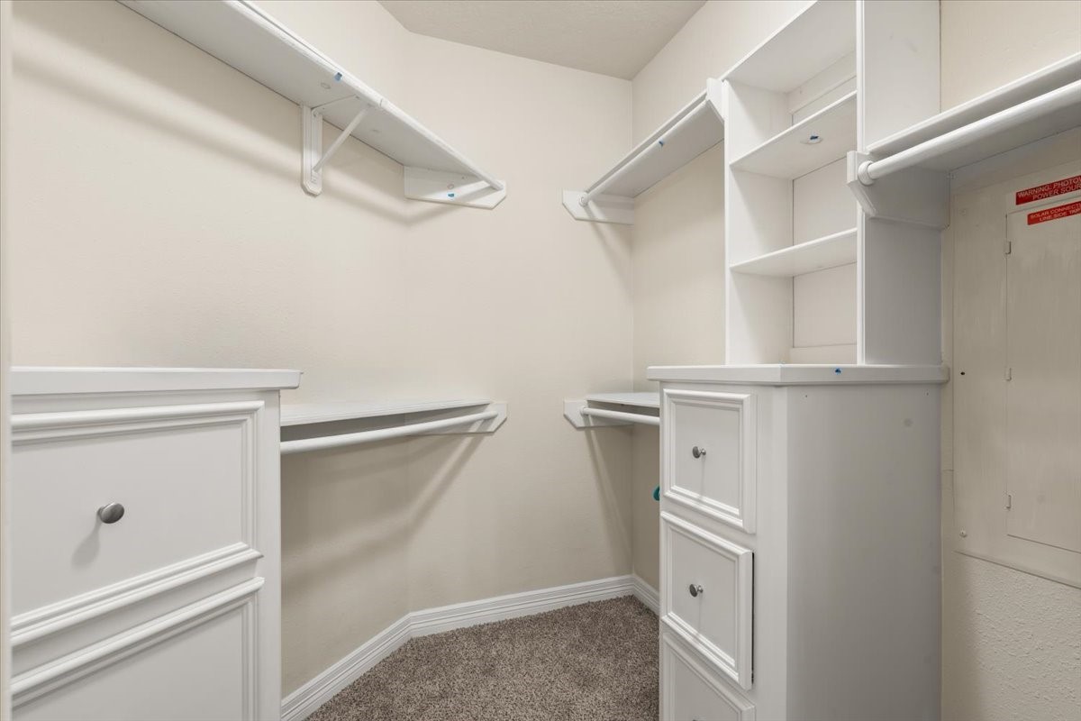 Primary closet with built in drawers and cabinets