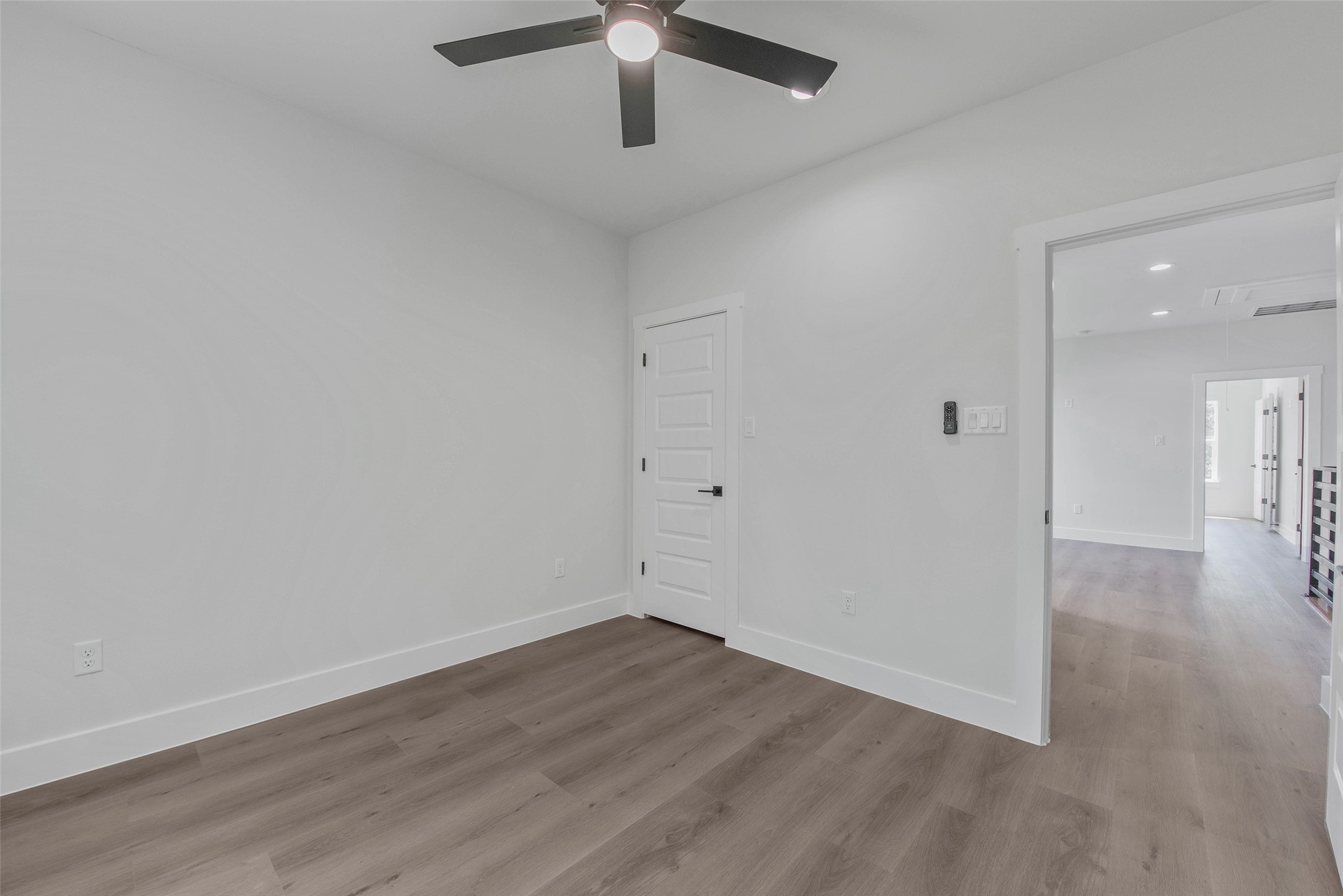 One of two secondary bedrooms, featuring a closet, no carpet, and a clean, modern finish.