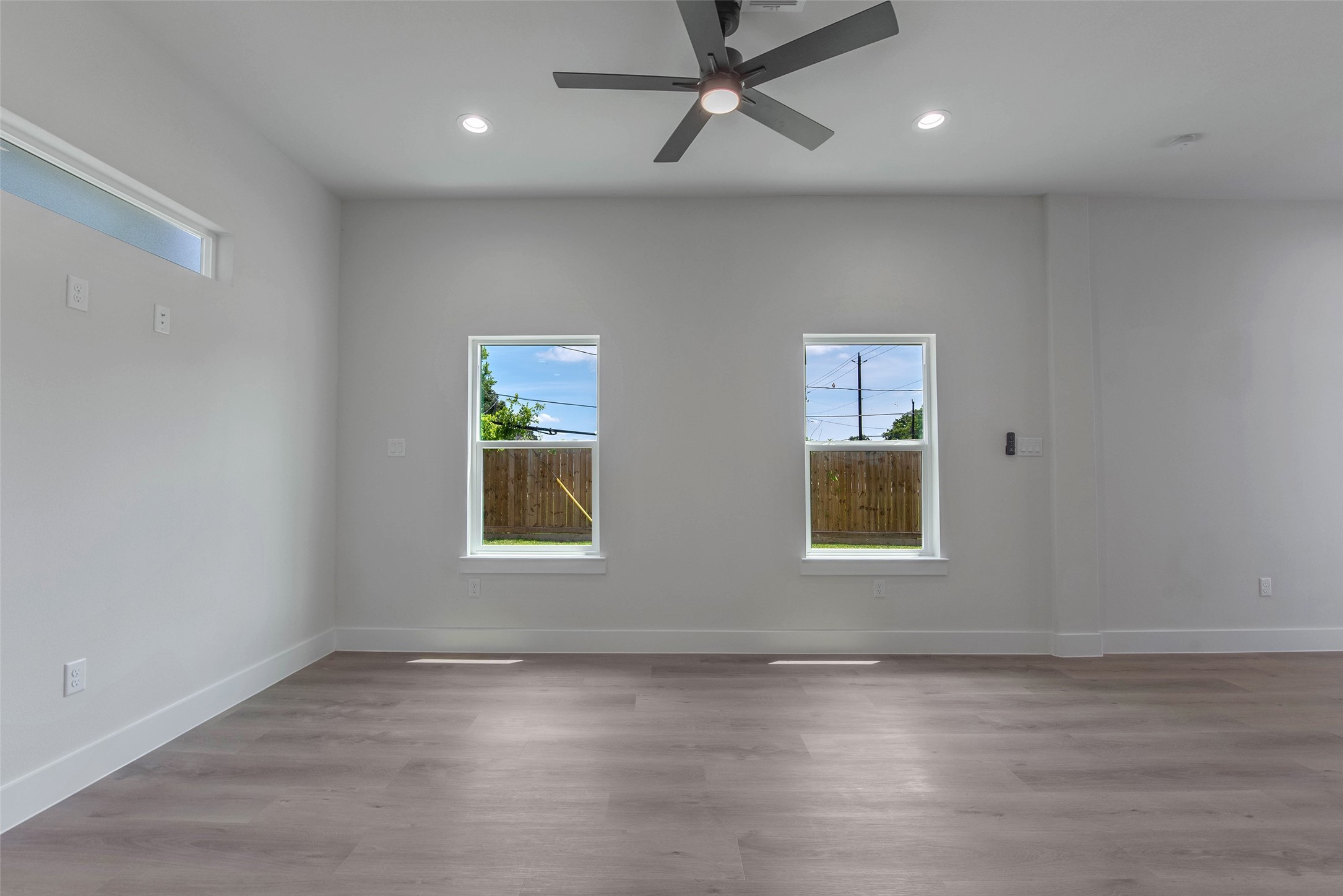 Another look at the inviting living and dining space, filled with natural light from the windows and an elegant transom window. The bright, open feel creates a welcoming setting for everyday living and entertaining.