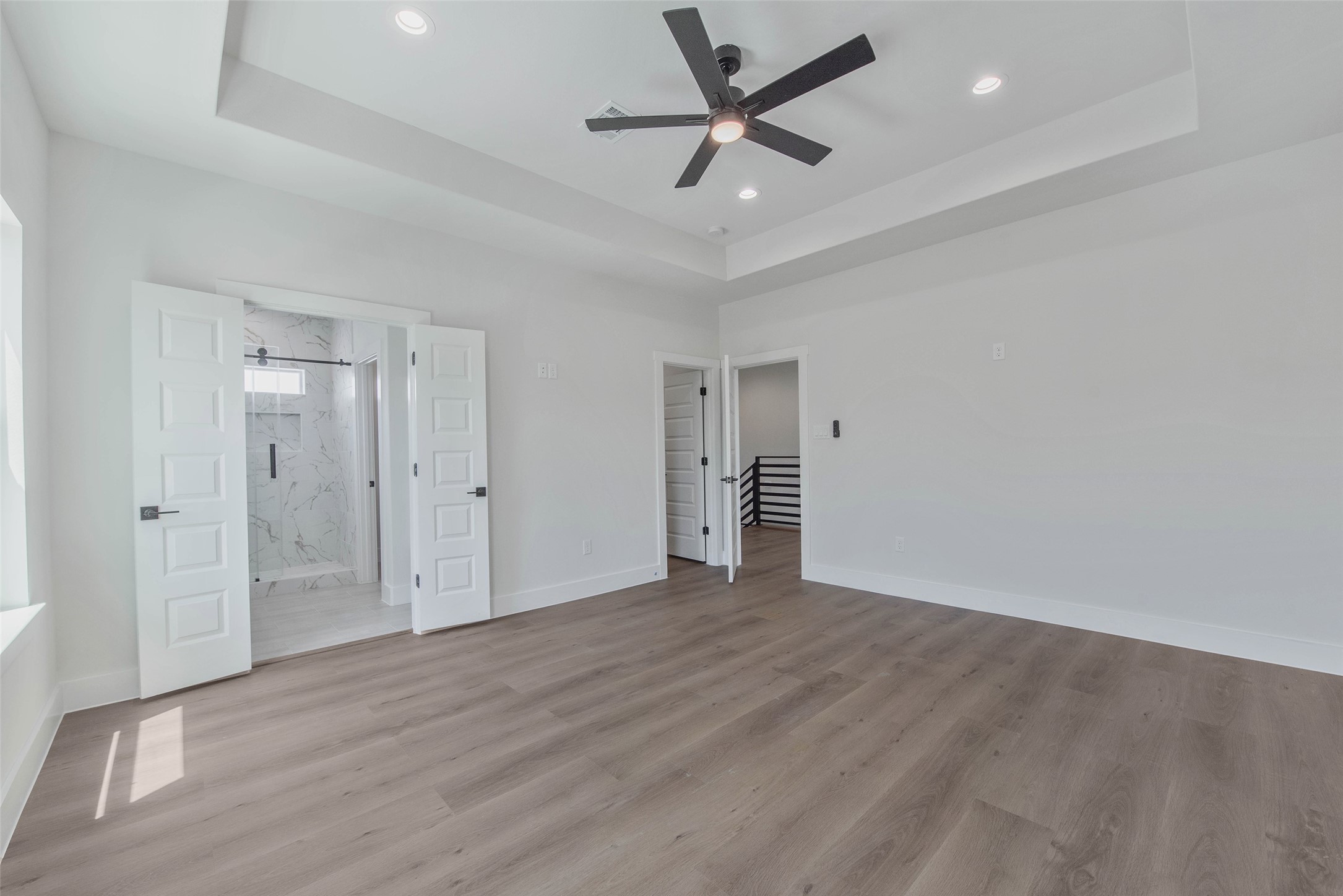 A large, light-filled bedroom offers a bright and comfortable retreat.
