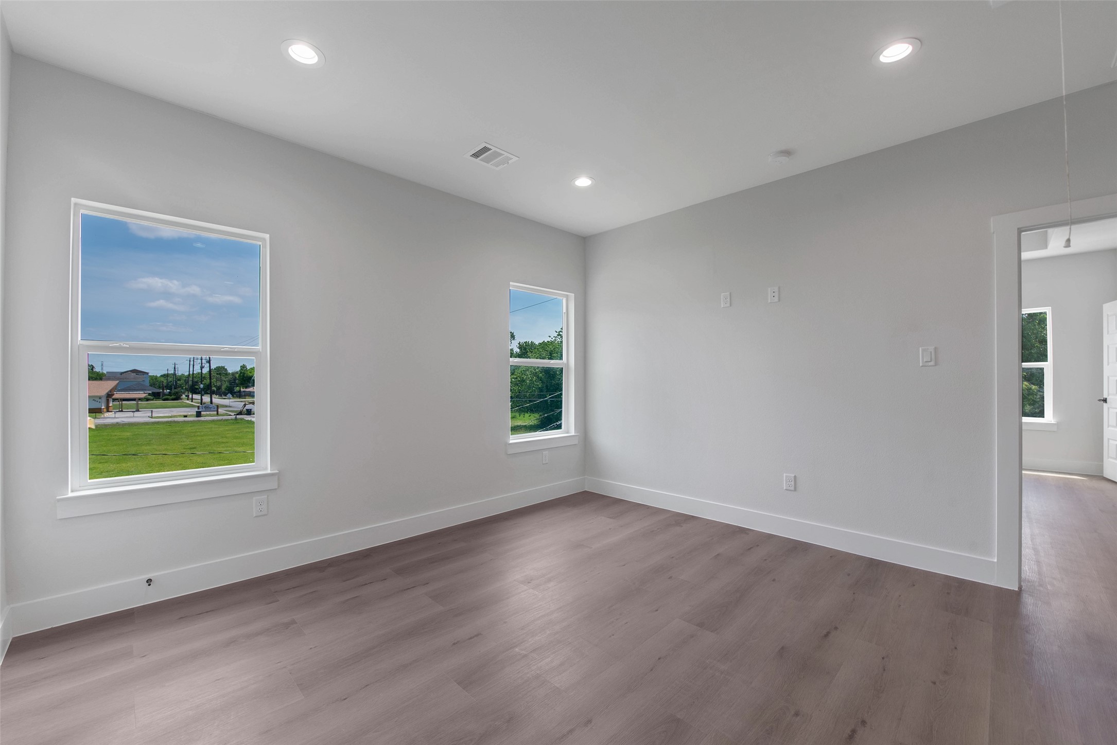 Another angle of the flexible upstairs space, showcasing its open feel and the convenient doorway leading directly to the primary suite.