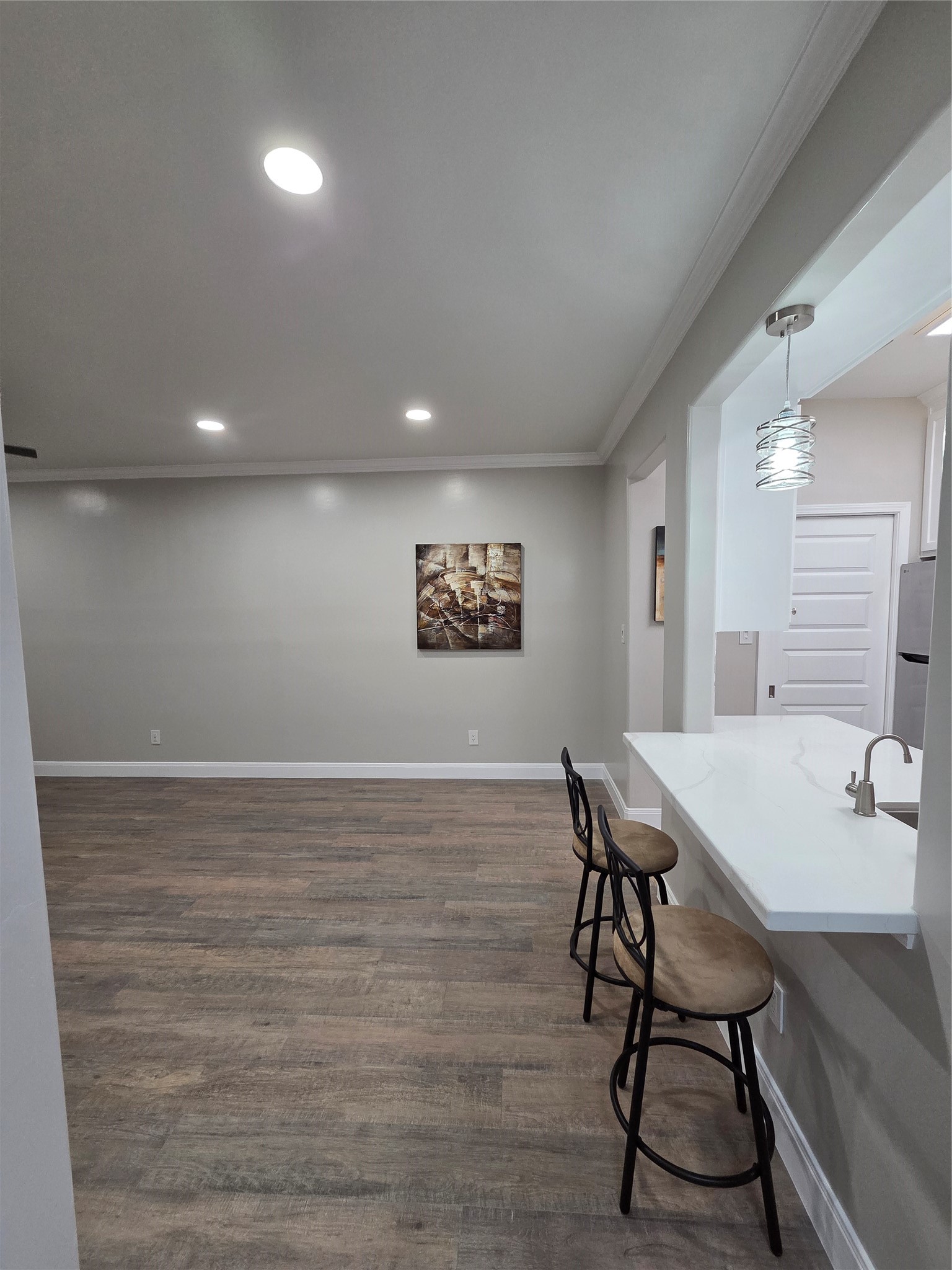 Dining room offers recess lighting, crown molding, Laminate flooring and 5 inch baseboards.