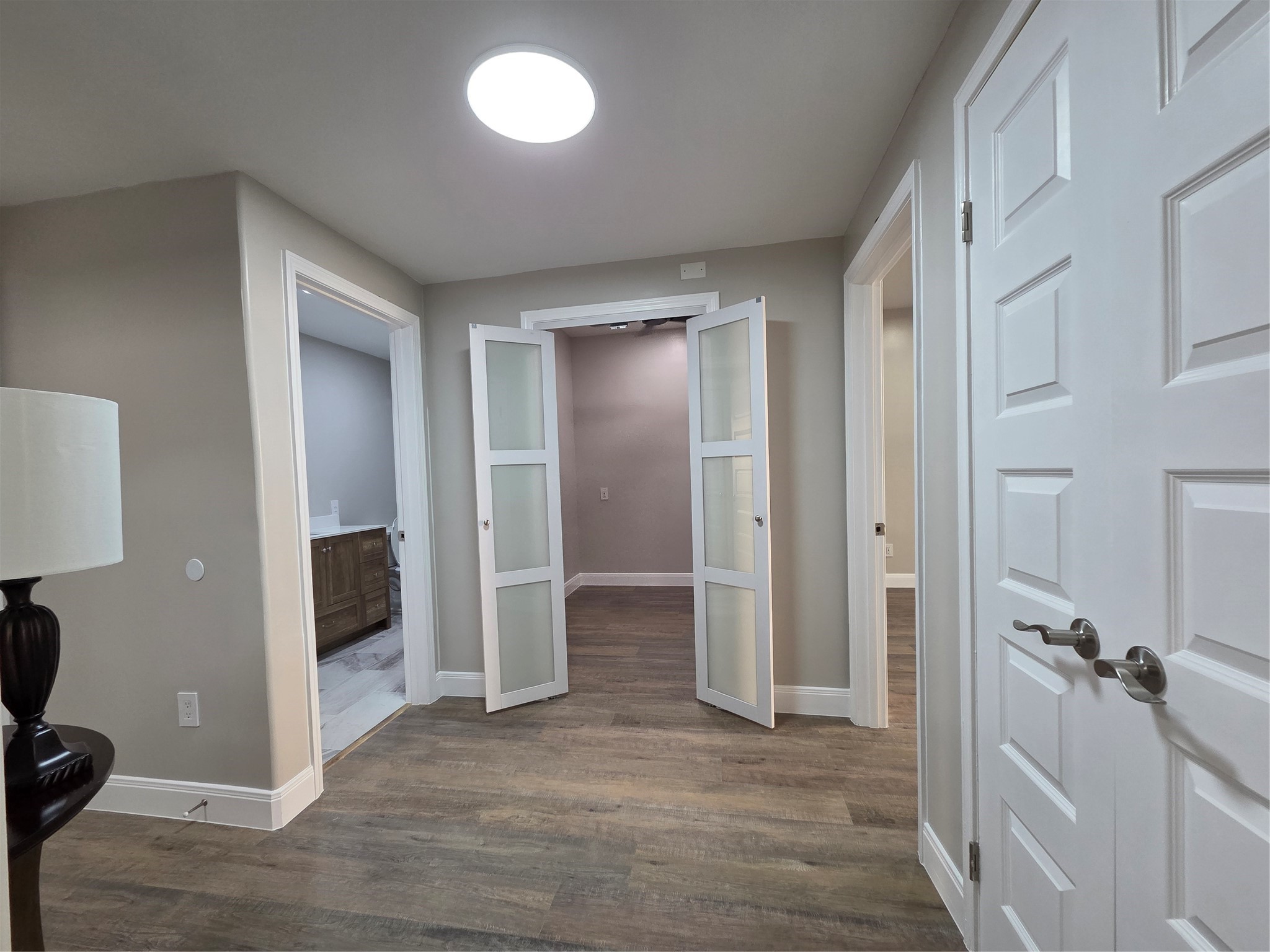 View of office from dining room area! Office offers frosted glass doors for privacy.