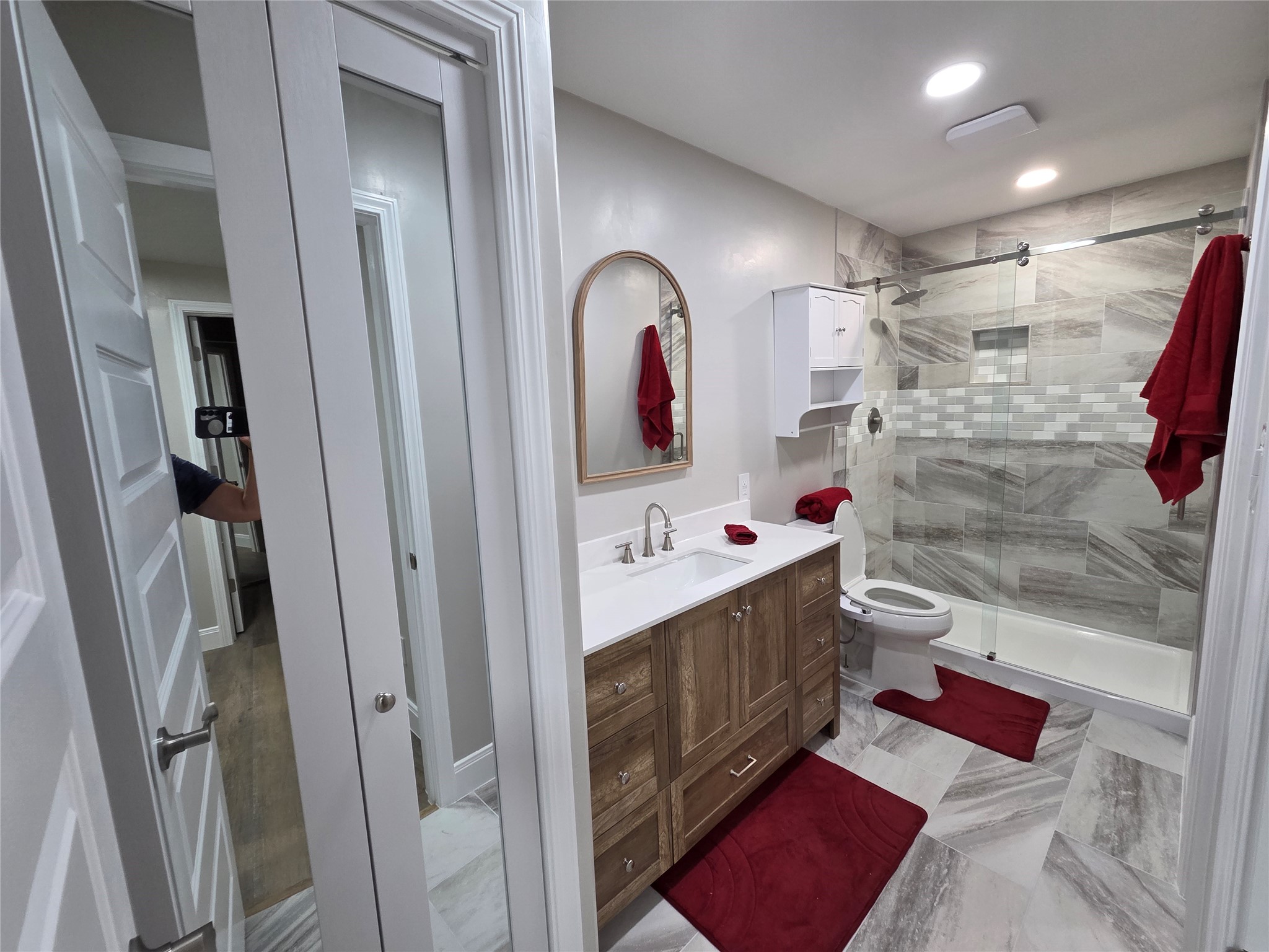 The bathroom offers procelin tile, frameless walkin shower, mirror linen closet door, bidet a vanity with extra storage space, recess lighting and ac vent and fan!