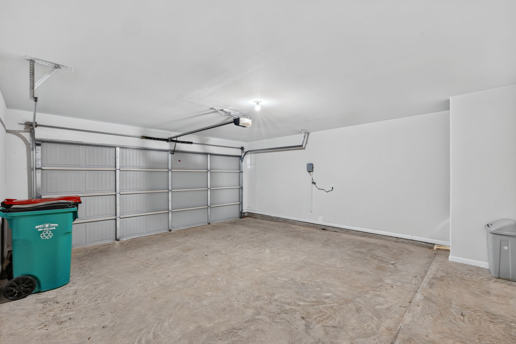An attached two-car garage with an automatic door opener and plenty of room for storage.