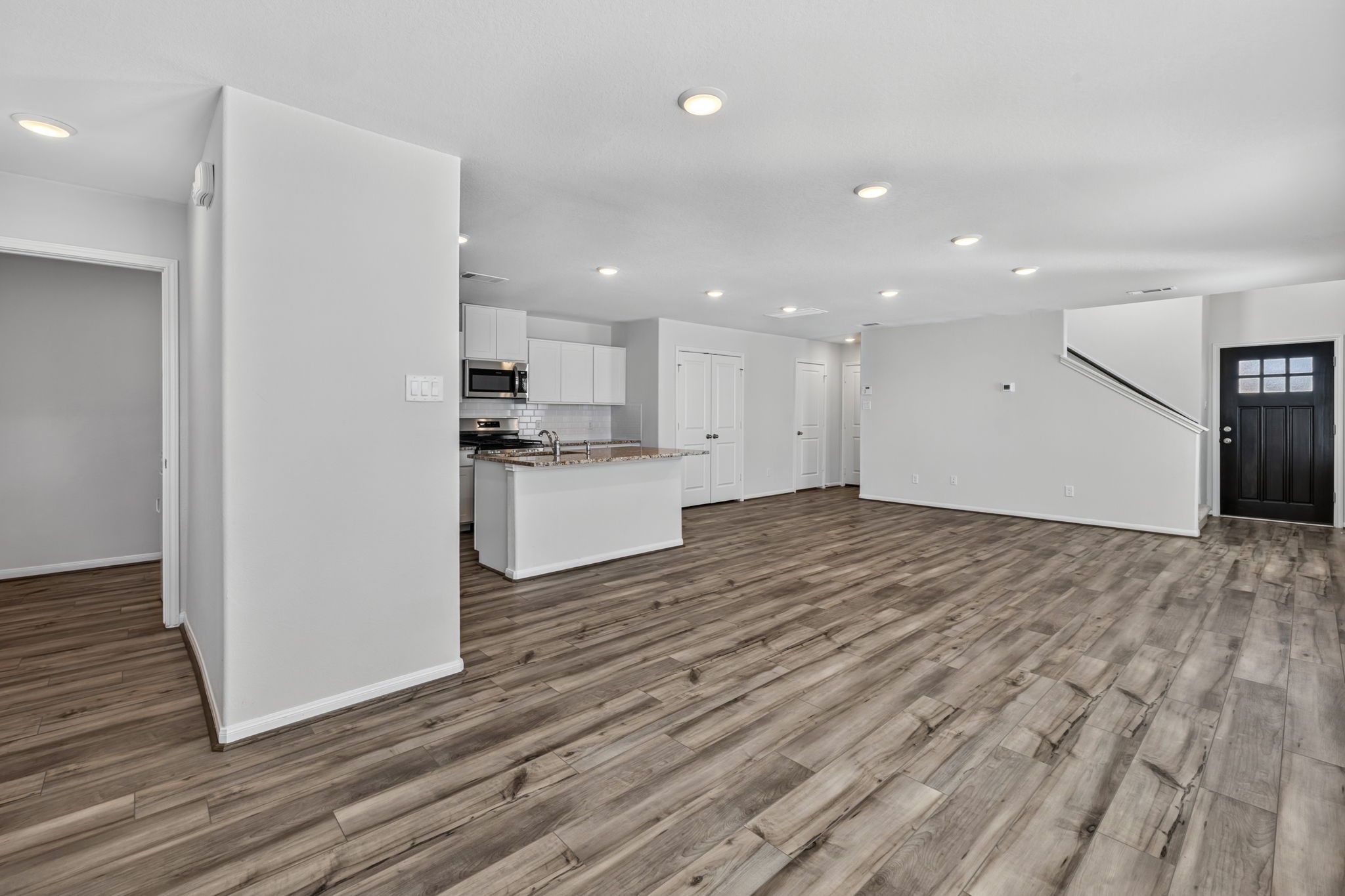 LAUNDRY ROOM - A dedicated laundry room with a hanging rod and shelf, room for a full-size washer and dryer located near the primary bedroom.