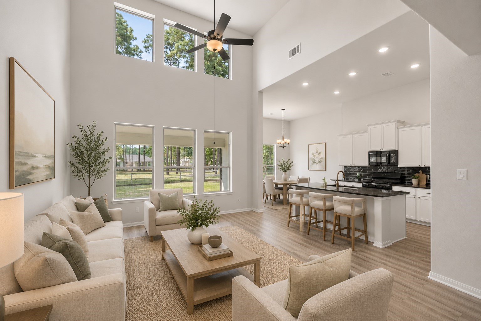 Spacious open-concept living area with soaring ceilings and abundant natural light, seamlessly connecting to a modern kitchen. *Virtually staged Spacious open-concept living area with soaring ceilings and abundant natural light, seamlessly connecting to a modern kitchen. *Virtually staged
