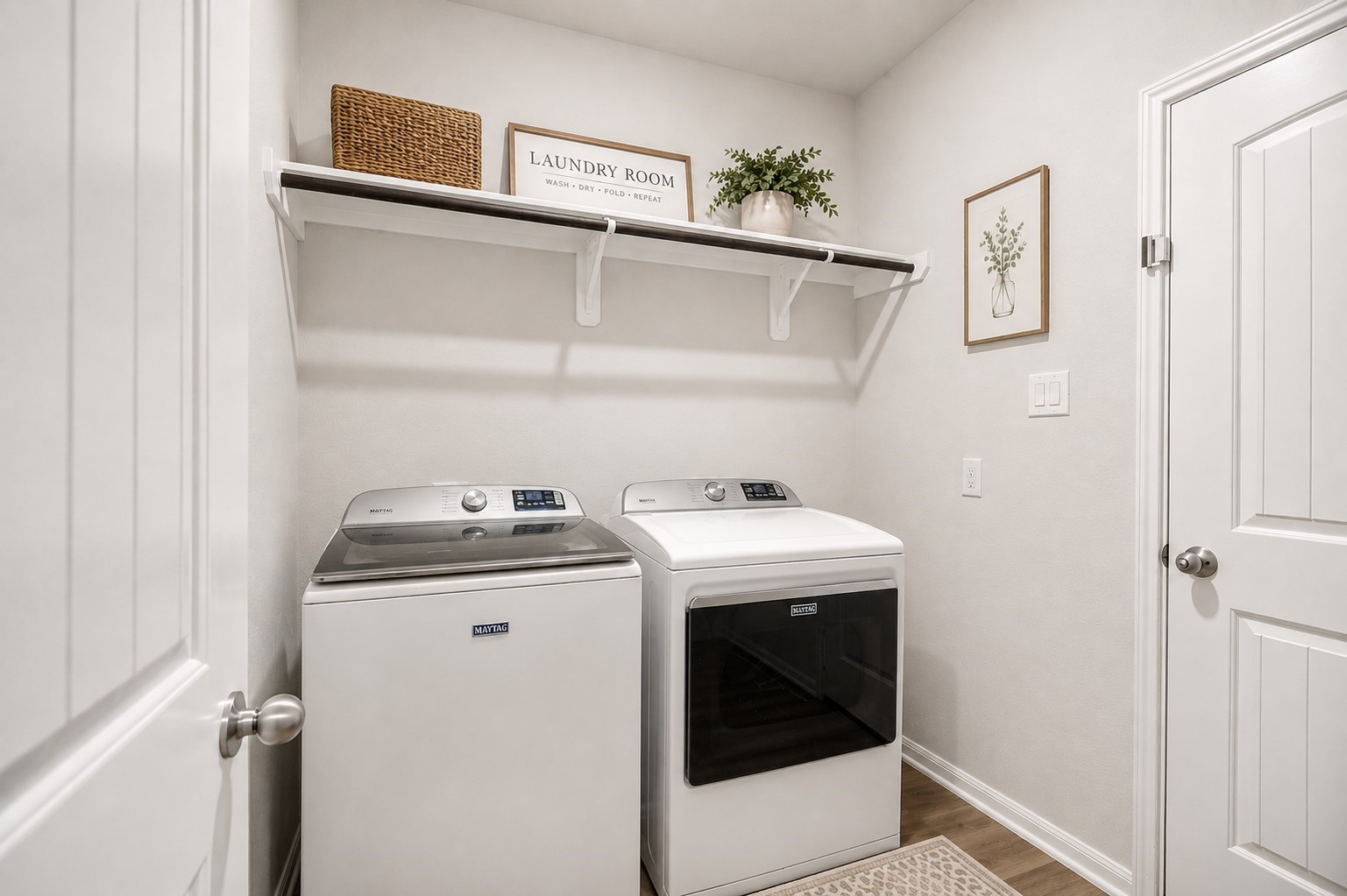 Bright and efficient laundry room featuring modern appliances, open shelving for storage. (washer/dryer can stay if you prefer.)