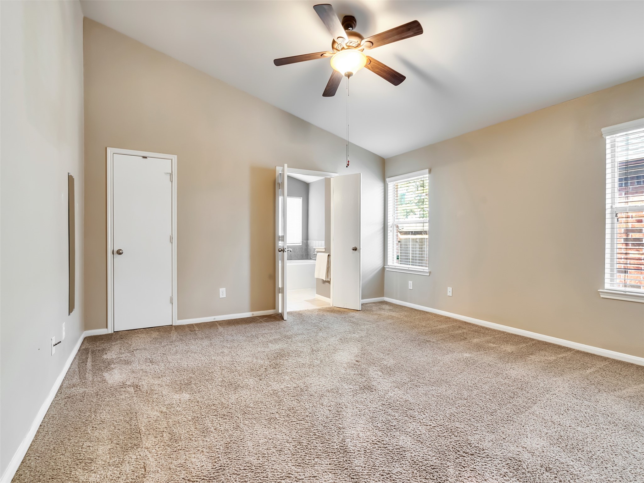 The spacious primary suite offers the perfect place to unwind, complete with a large walk-in closet that provides plenty of storage and organization.