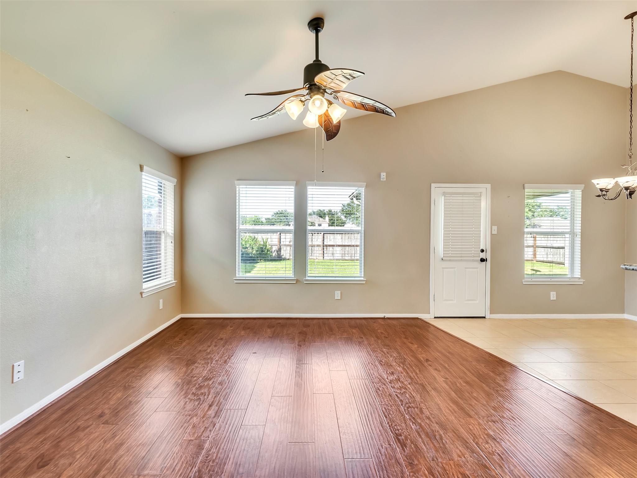 Bright and inviting living area with a back door that opens to a covered patio, creating the perfect indoor-outdoor living space.