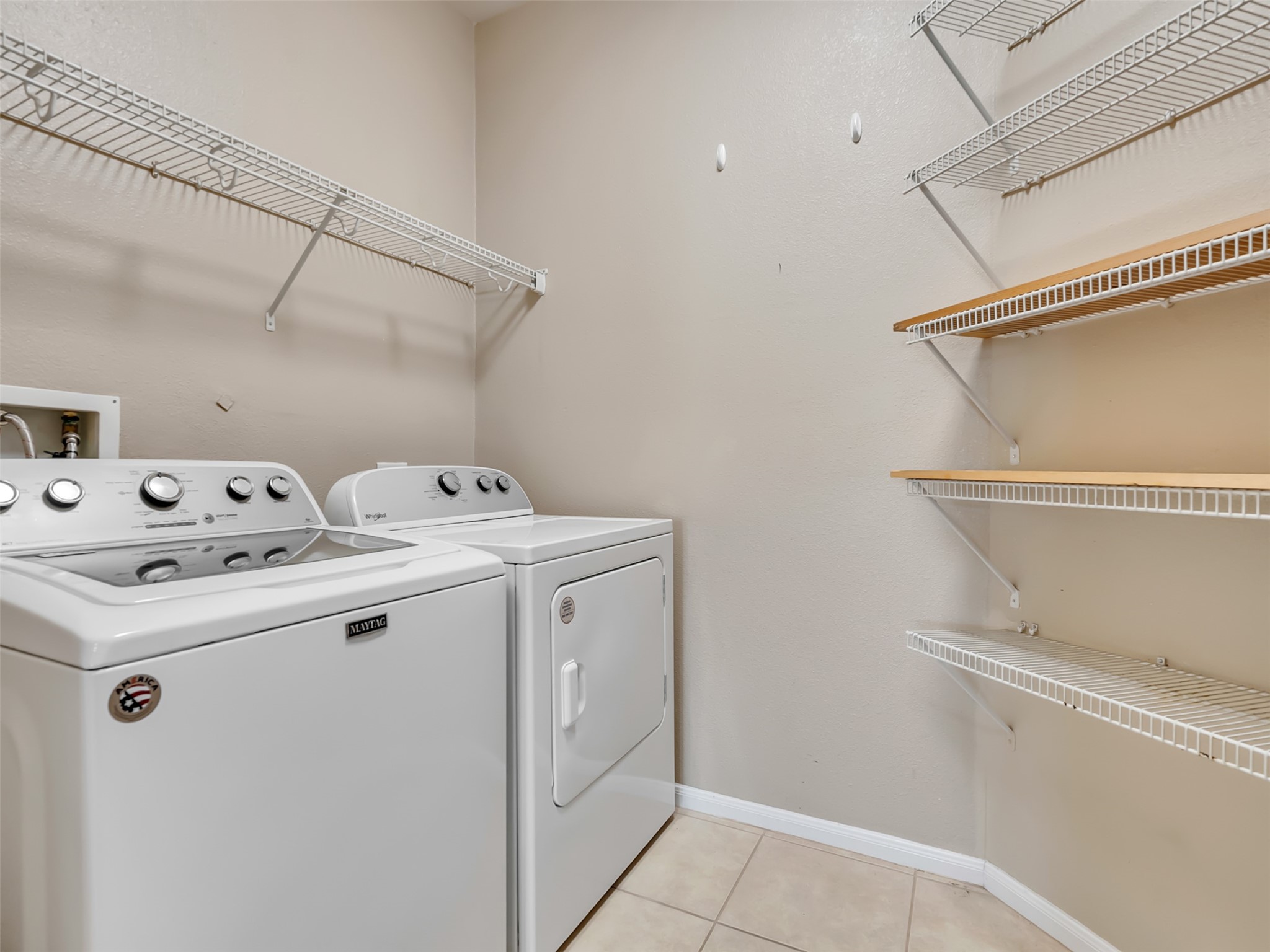 This versatile utility room offers the best of both worlds, combining a spacious laundry area with a convenient walk-in pantry.