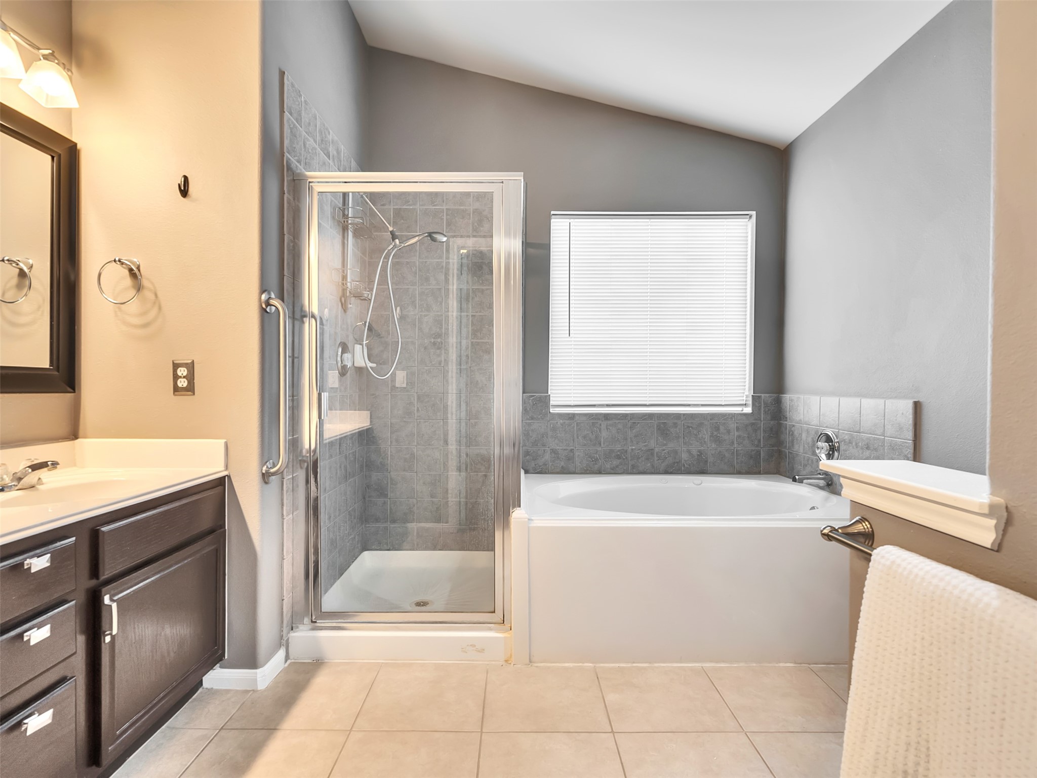 Featuring a luxurious soaking, whirlpool tub and a separate walk-in shower, this private retreat is designed for both relaxation and everyday convenience