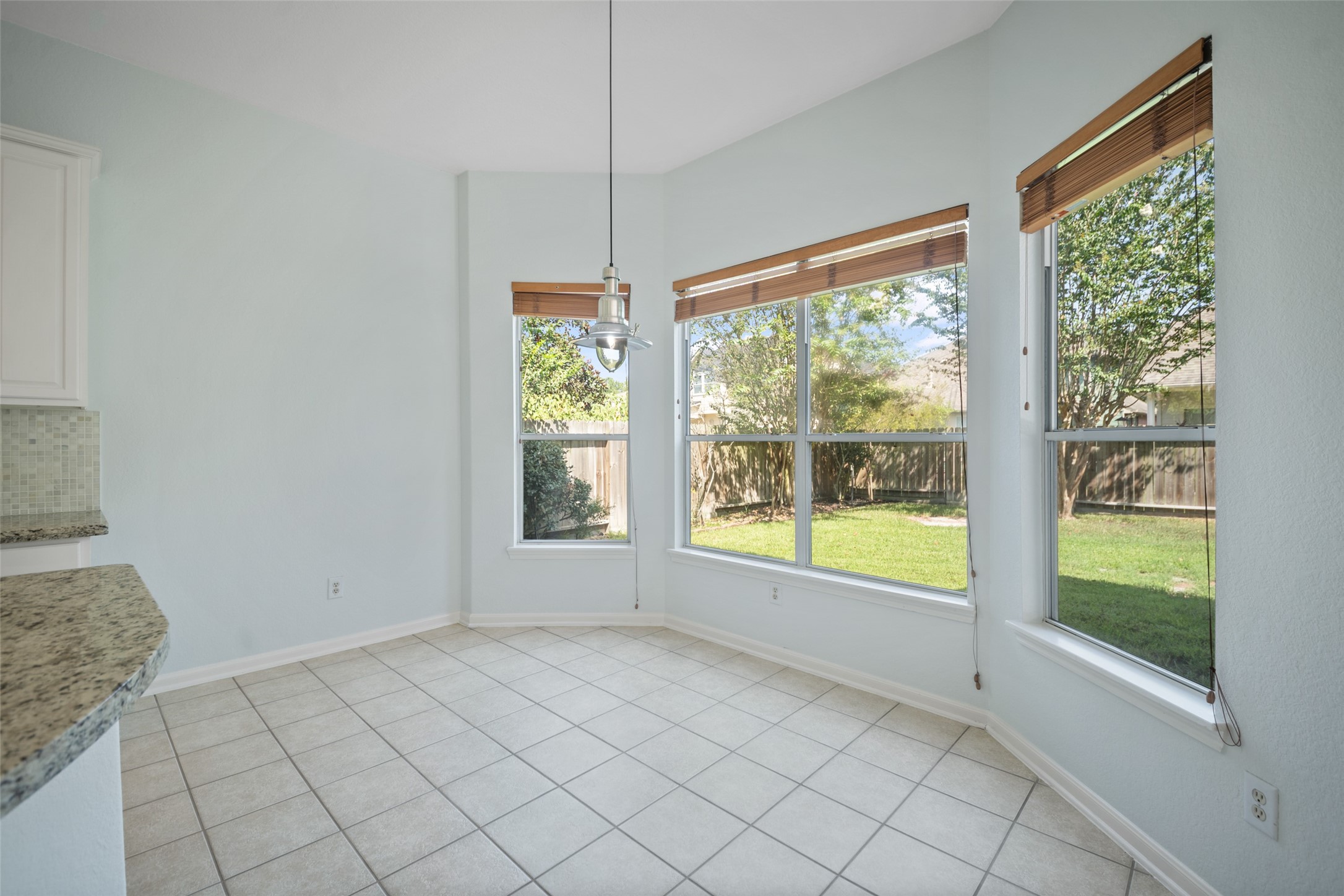breakfast nook gleaming with natural light and great view of backyard