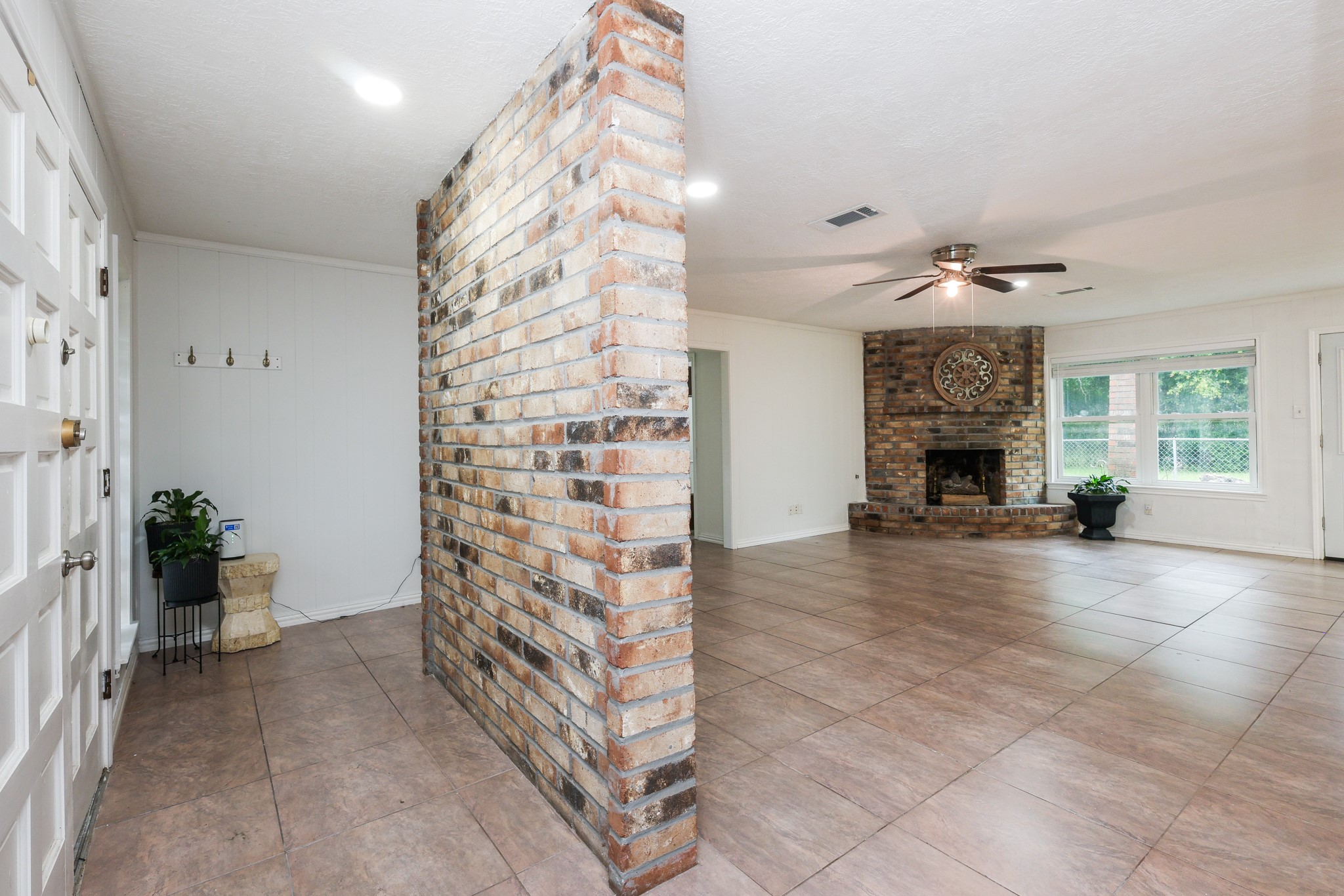Foyer with brick wall feature to living room Foyer with brick wall feature to living room
