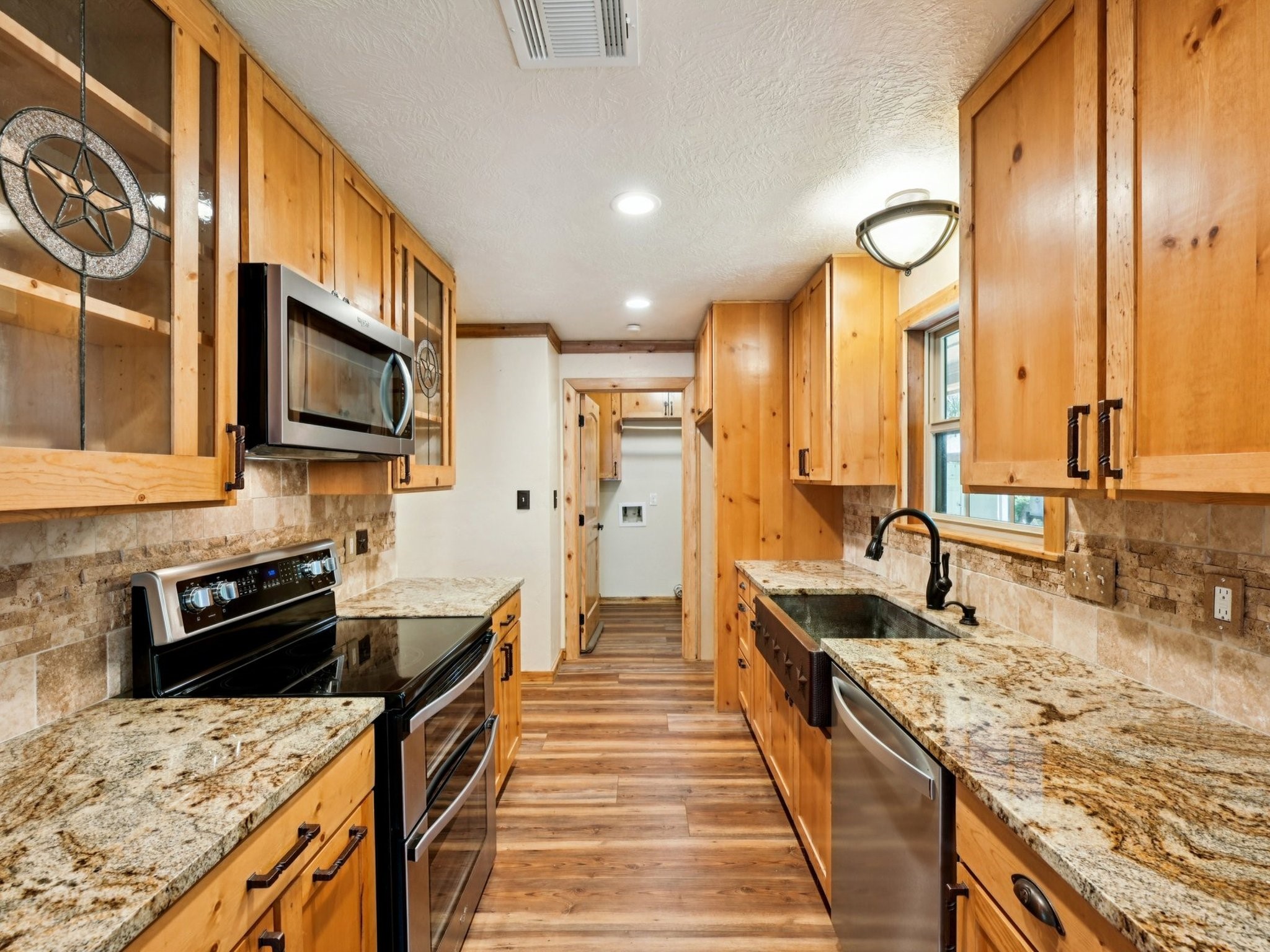 The Kitchen has dazzling granite counters, a beautiful backsplash with star inlay, and stainless appliances.