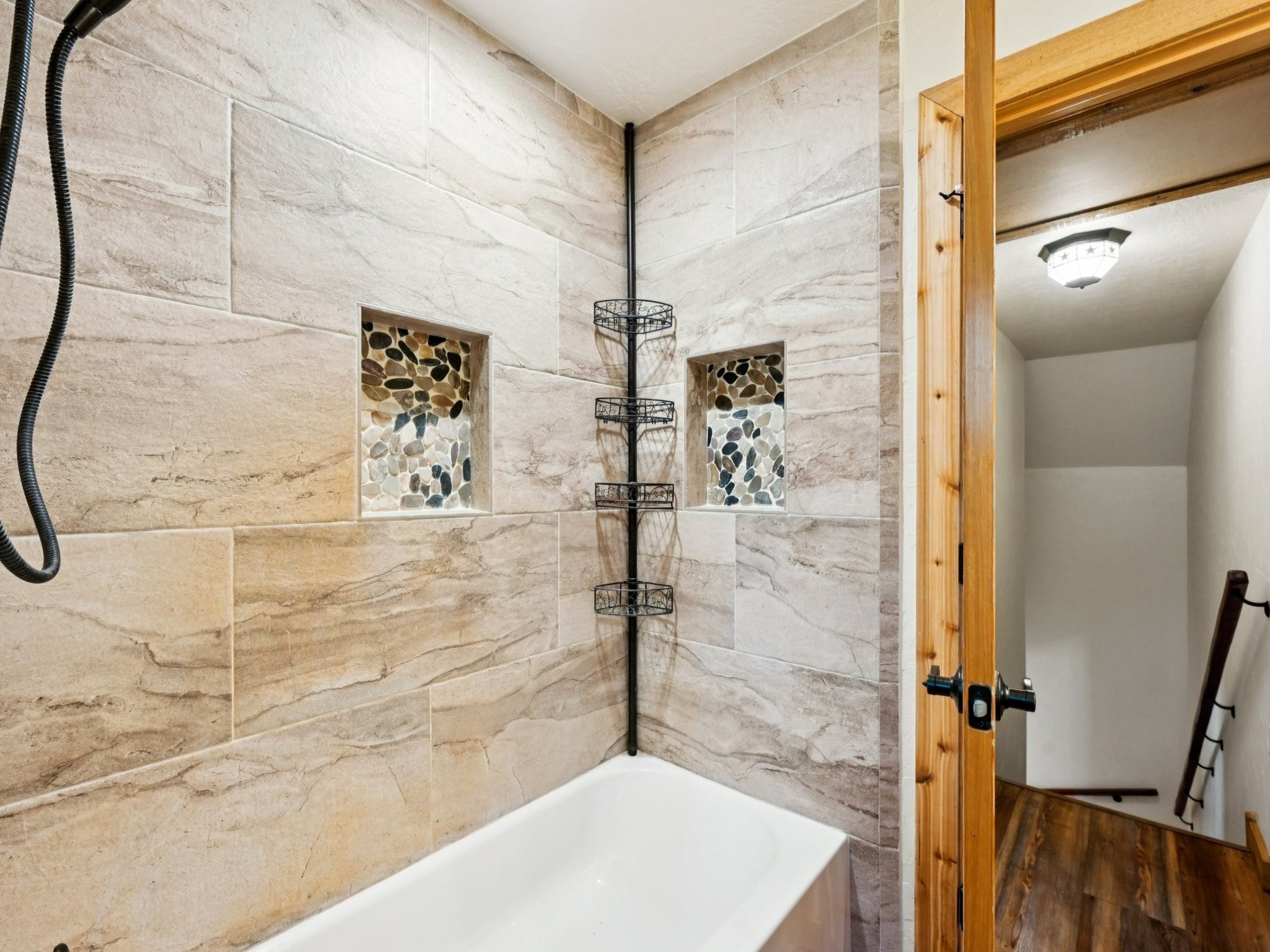 The Upstairs Bathroom has a tiled tub/shower enclosure.