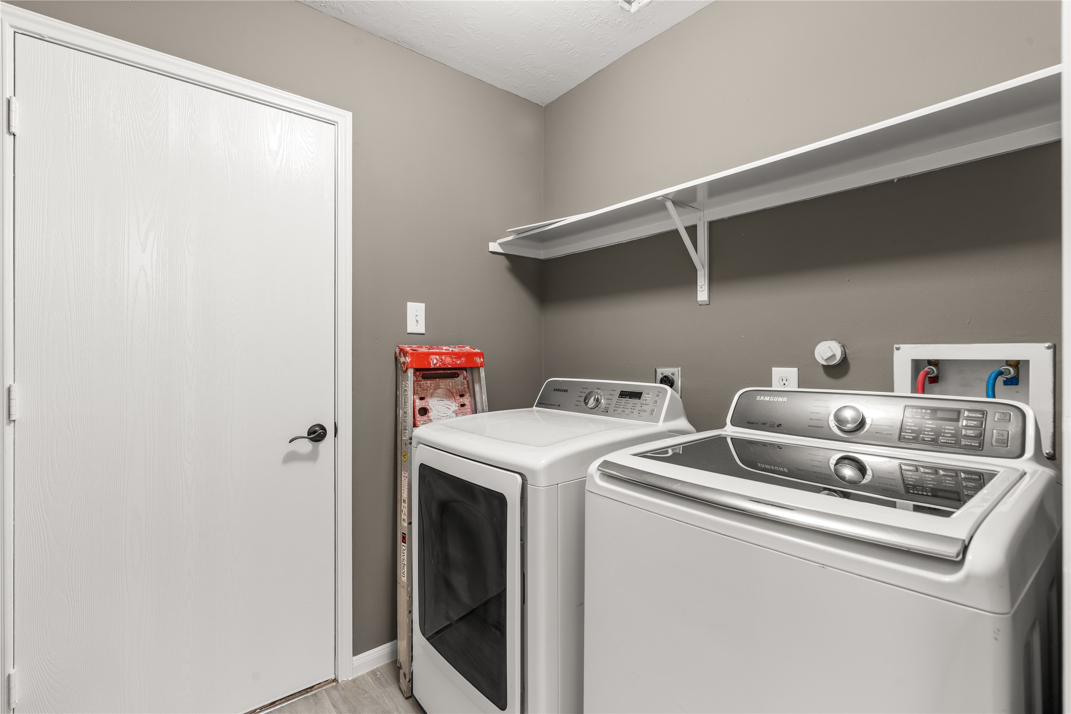 Utility room leading to the garage. Washer and dryer included!