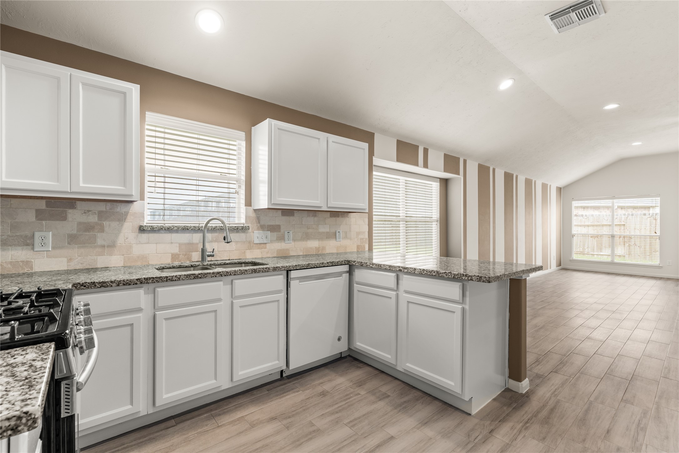 The open-concept design seamlessly connects the kitchen and living room, creating an ideal space for everyday living and entertaining.