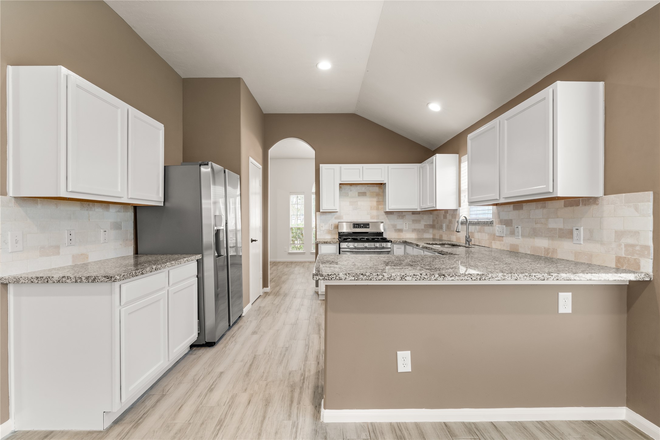 Designed with functionality in mind, this kitchen offers abundant cabinet storage and expansive counter space.