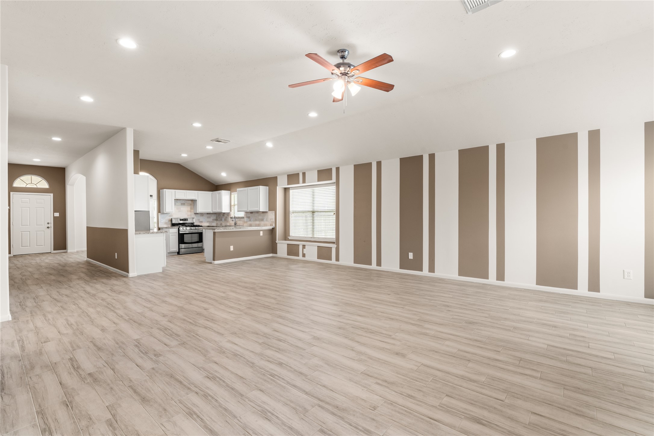 The eye-catching accent wall creates a stylish focal point while complementing the home's open-concept design.