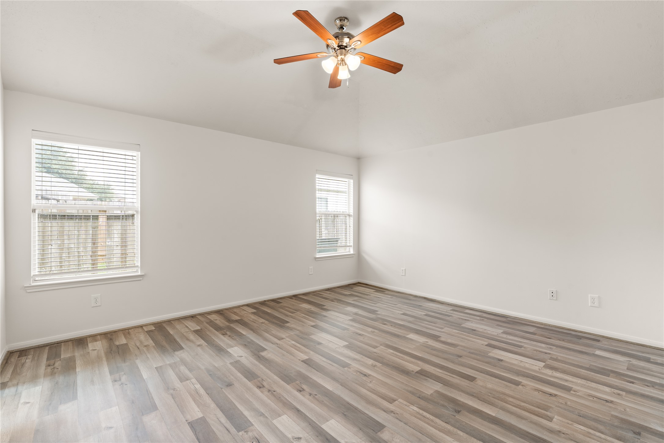 Wake up to abundant natural light in this inviting primary bedroom.