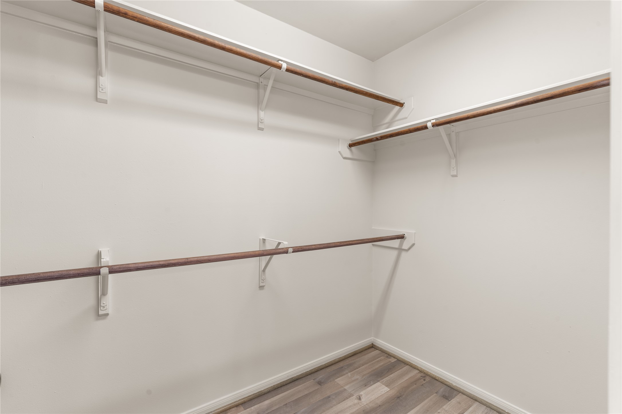 Spacious walk-in closet with ample hanging space and plenty of room for storage and organization.