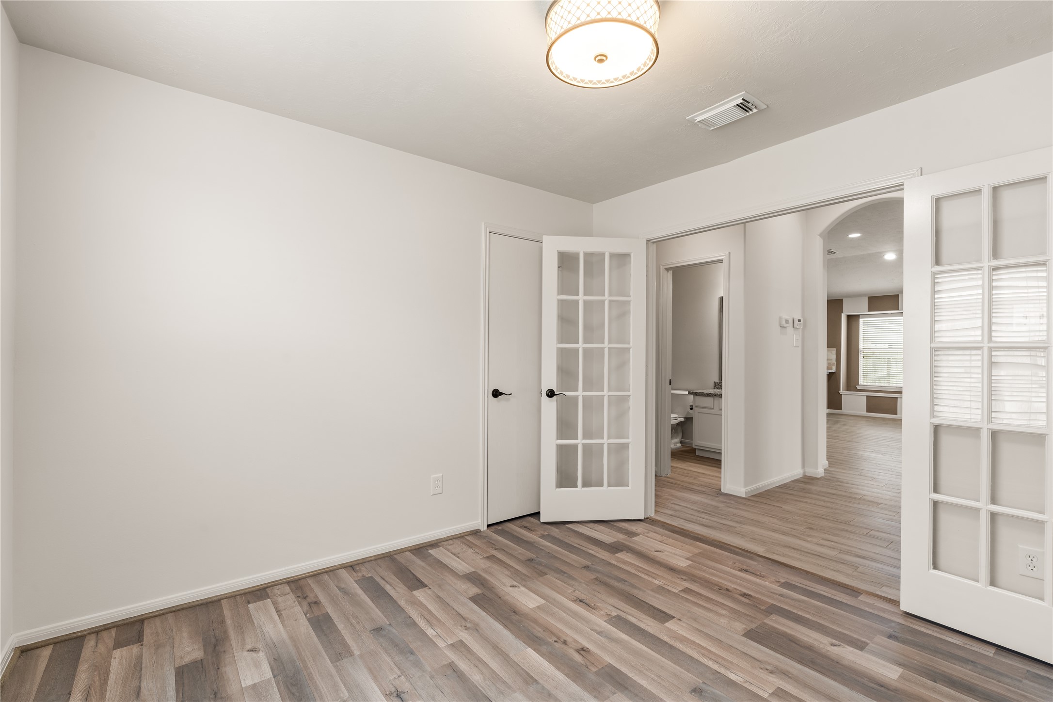 Flexible home office/ study enclosed by French doors.