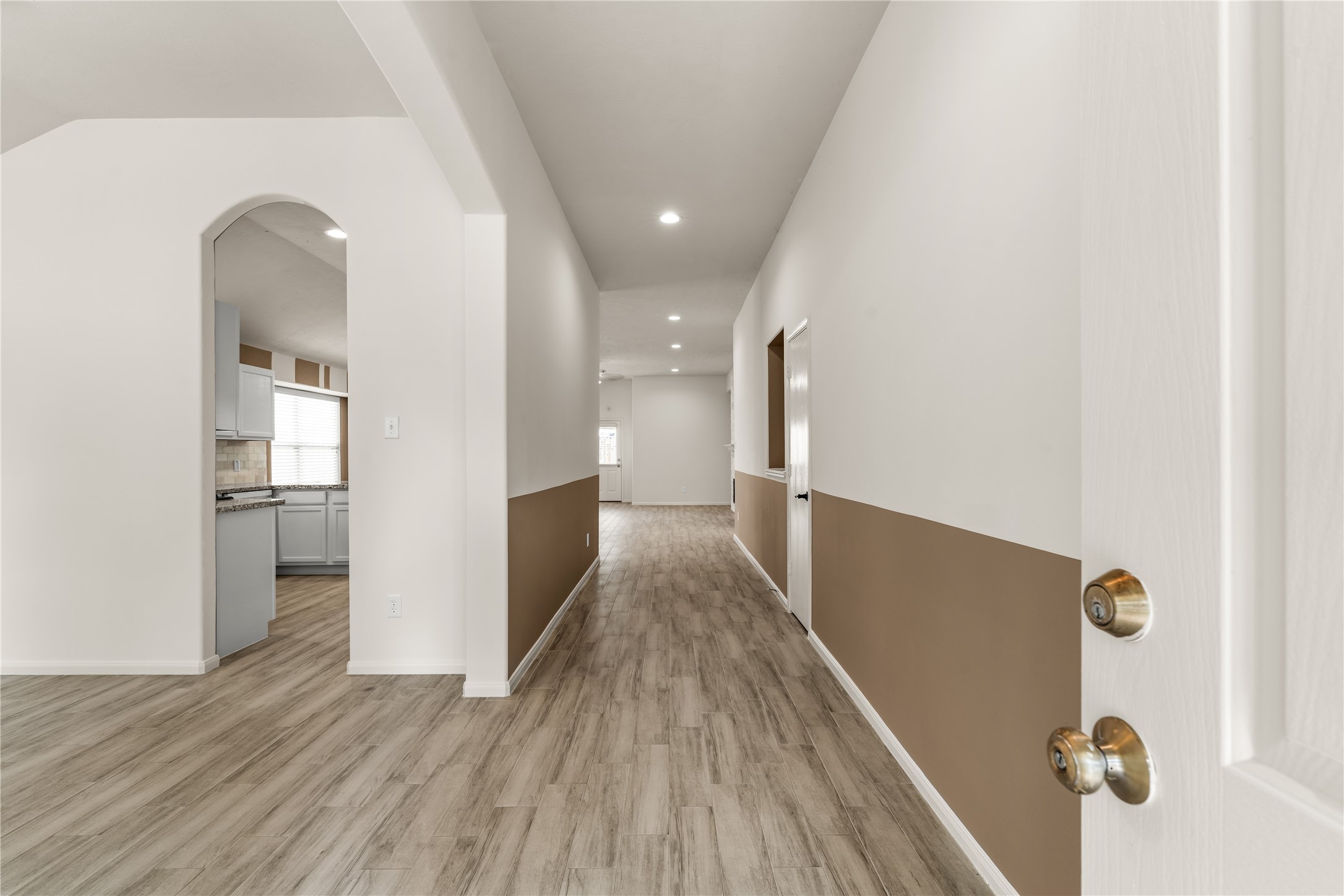 Welcoming foyer with sightlines to the dining area, kitchen, and living room.