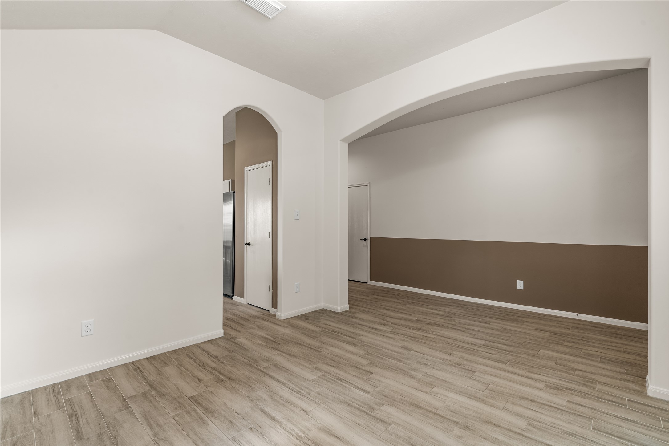 Updated vinyl flooring, fresh paint, and abundant natural light create a bright and inviting atmosphere throughout the home.