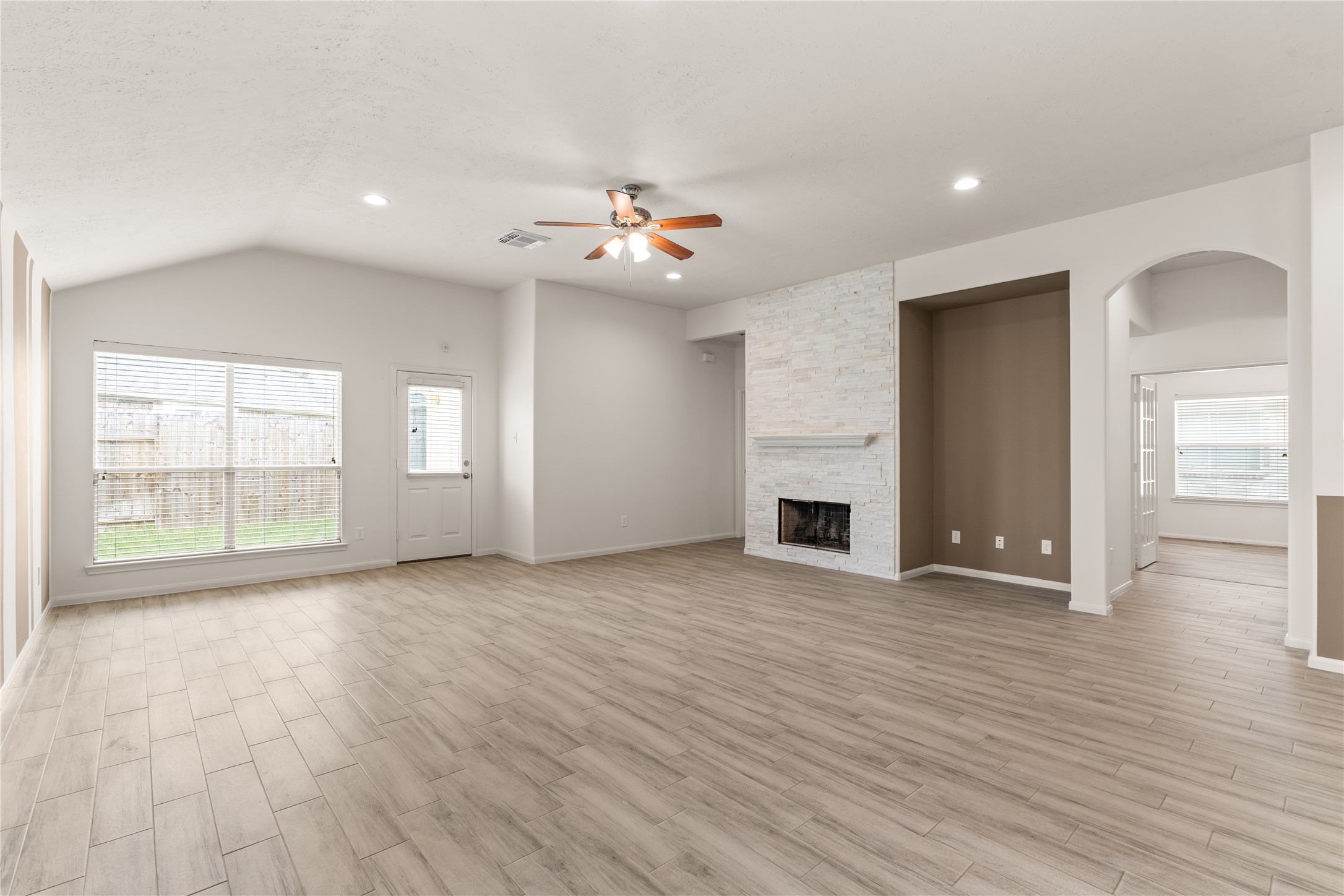 Multiple windows along the rear of the home bring in natural light and provide views of the backyard.