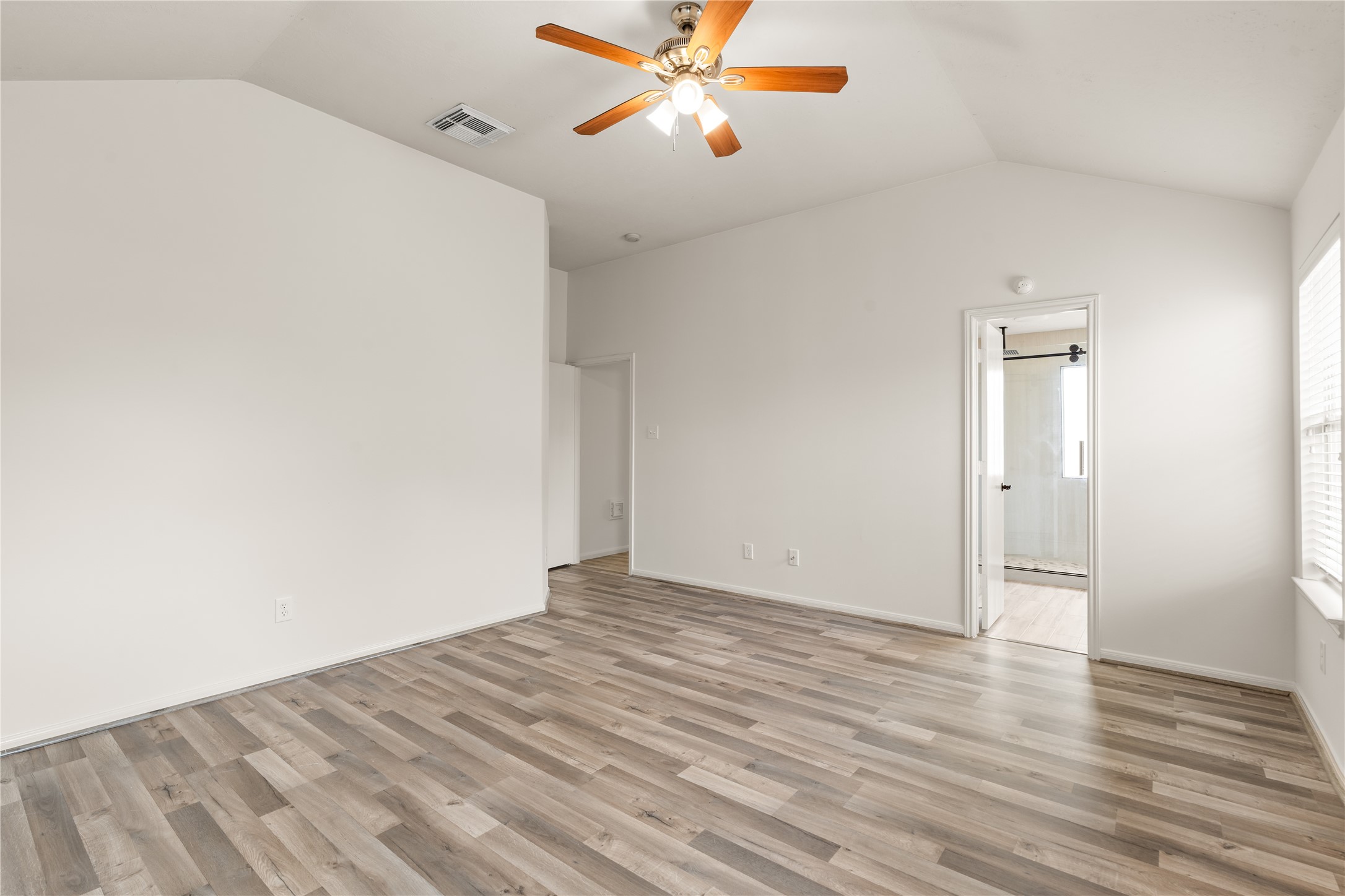 Generous primary bedroom with soaring ceilings.