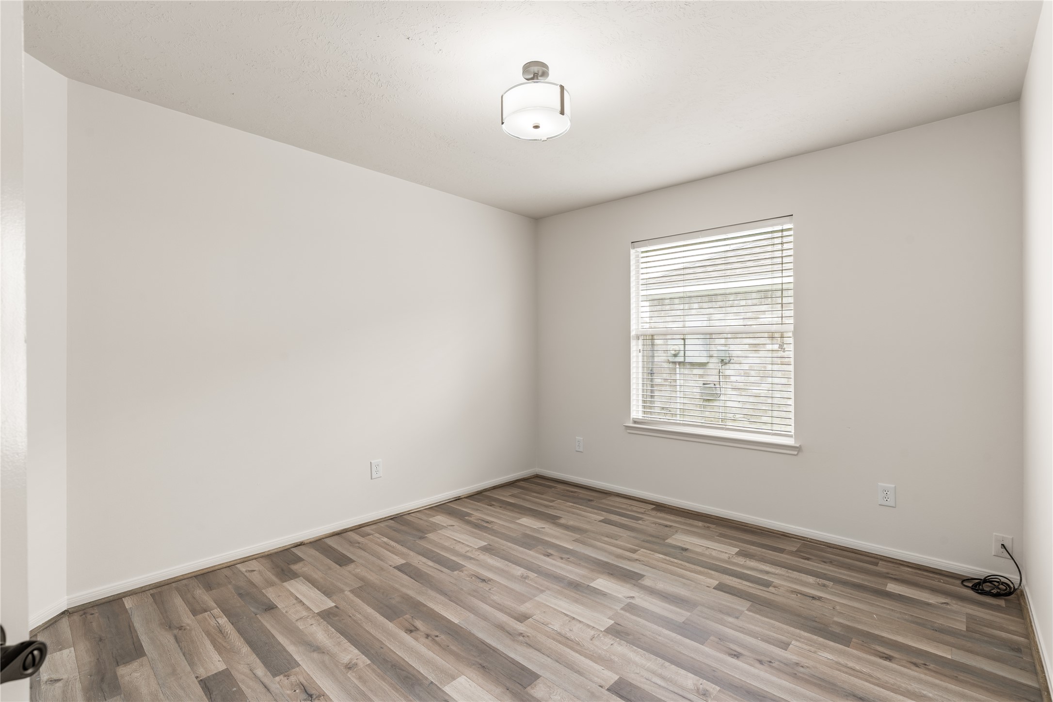 Large window fills the room with natural light, creating a bright and welcoming environment.
