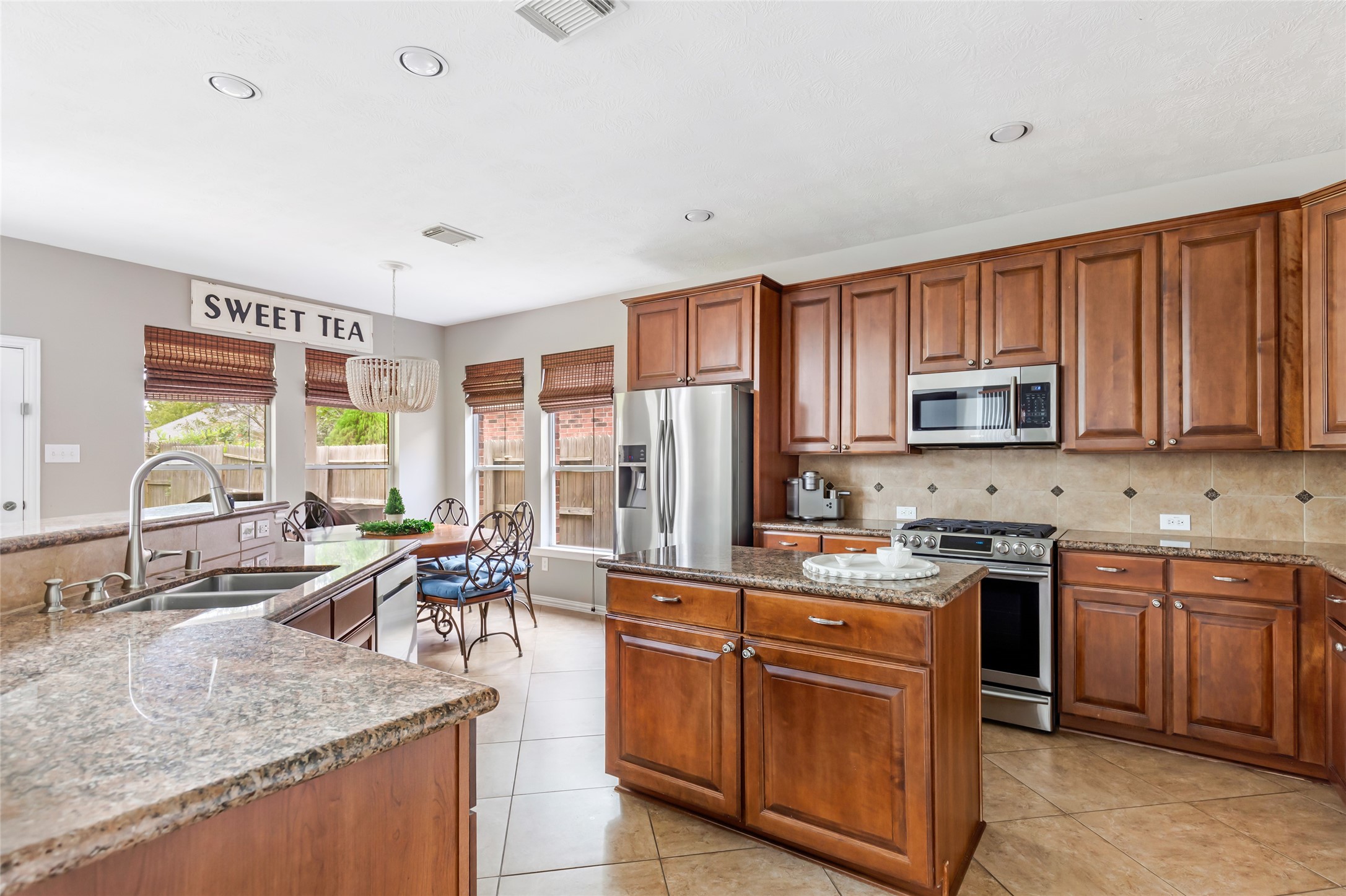 Kitchen with abundant wood cabinetry, generous counter space and stainless steel appliances