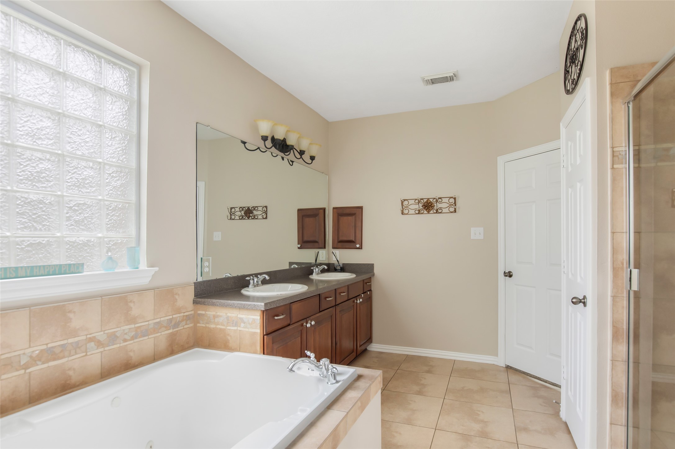 Generously sized primary bathroom with separate tub and shower area
