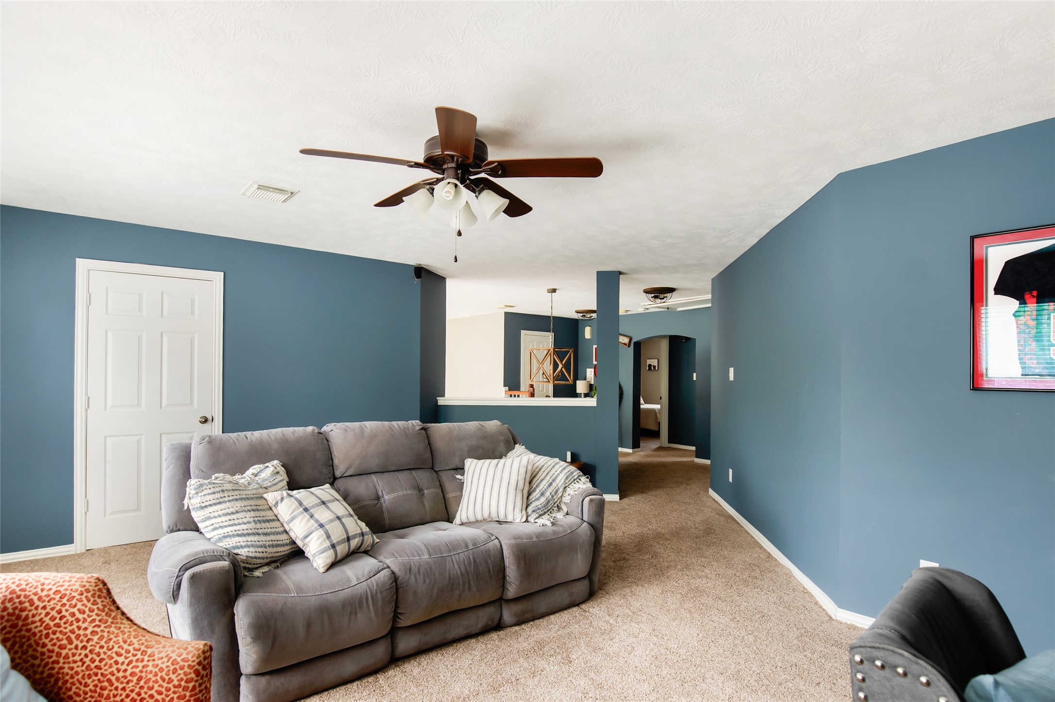 Game room with ceiling fan and room for multiple seating arrangements