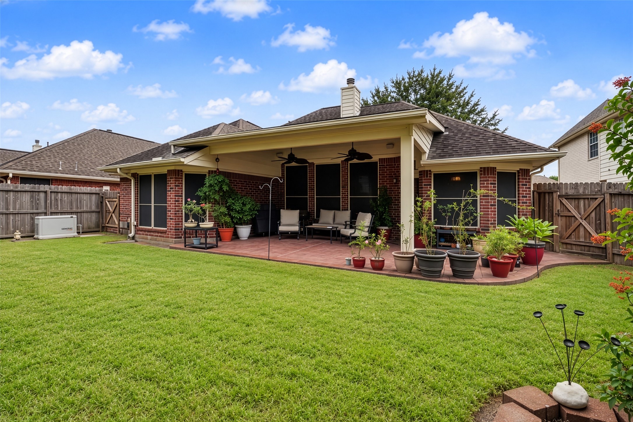 Gorgeous yard with Generac Generator and extended patio