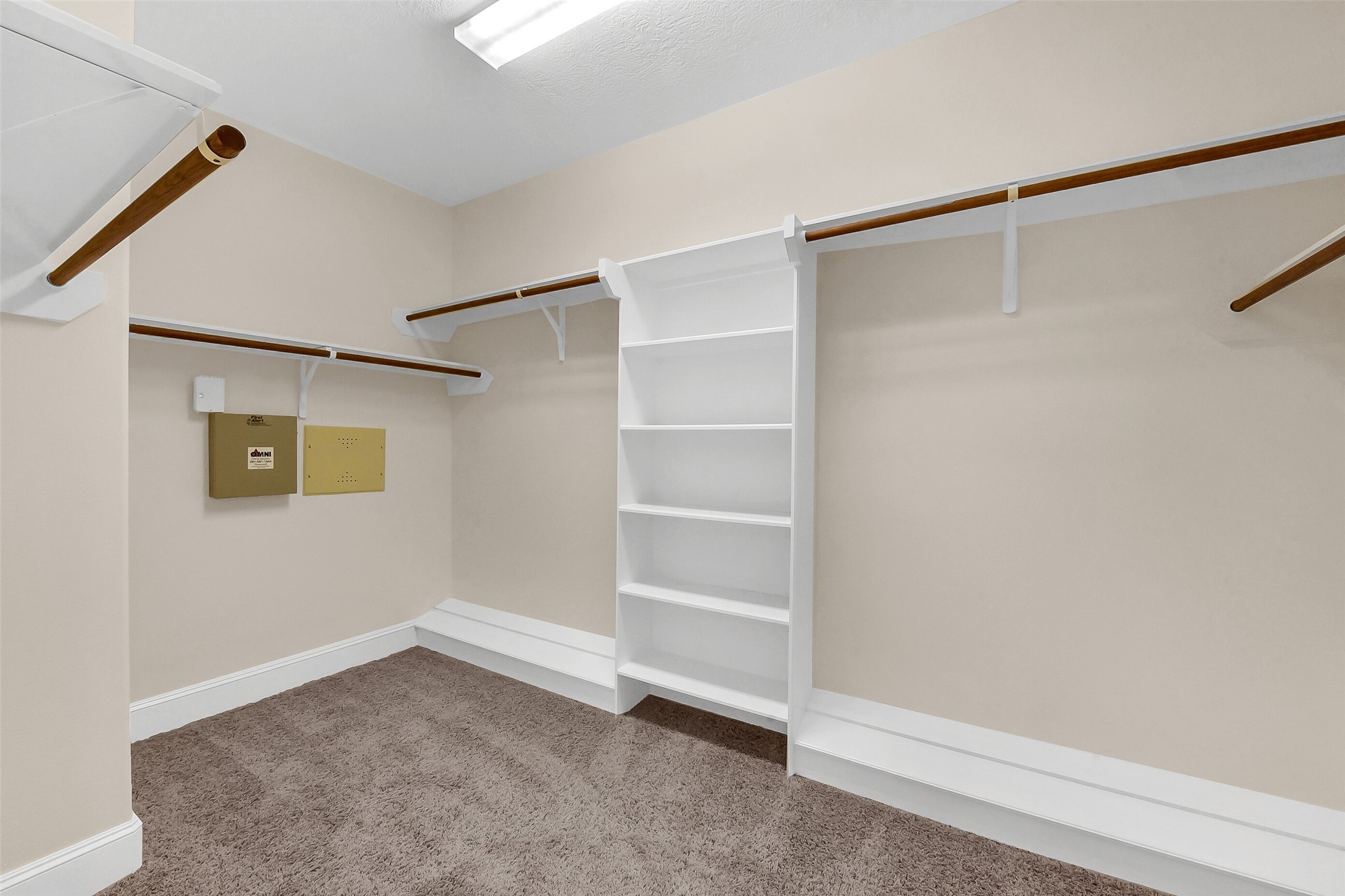 Oversized closet in the primary bedroom with shoe holders and shelves.