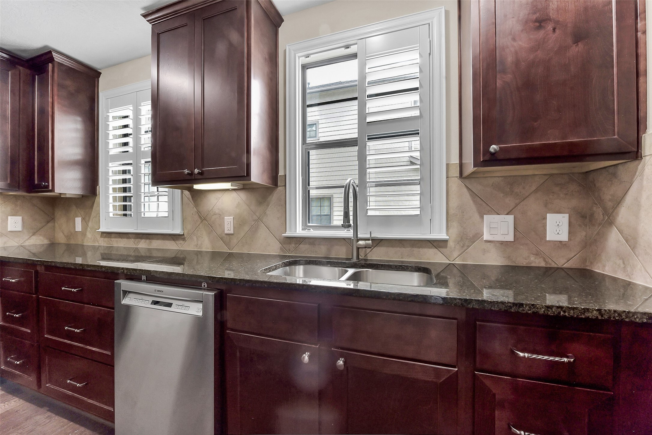 Windows in the kitchen allow natural light to filter in and the shutters give you the ability to adjust the amount of light that you want to let in.